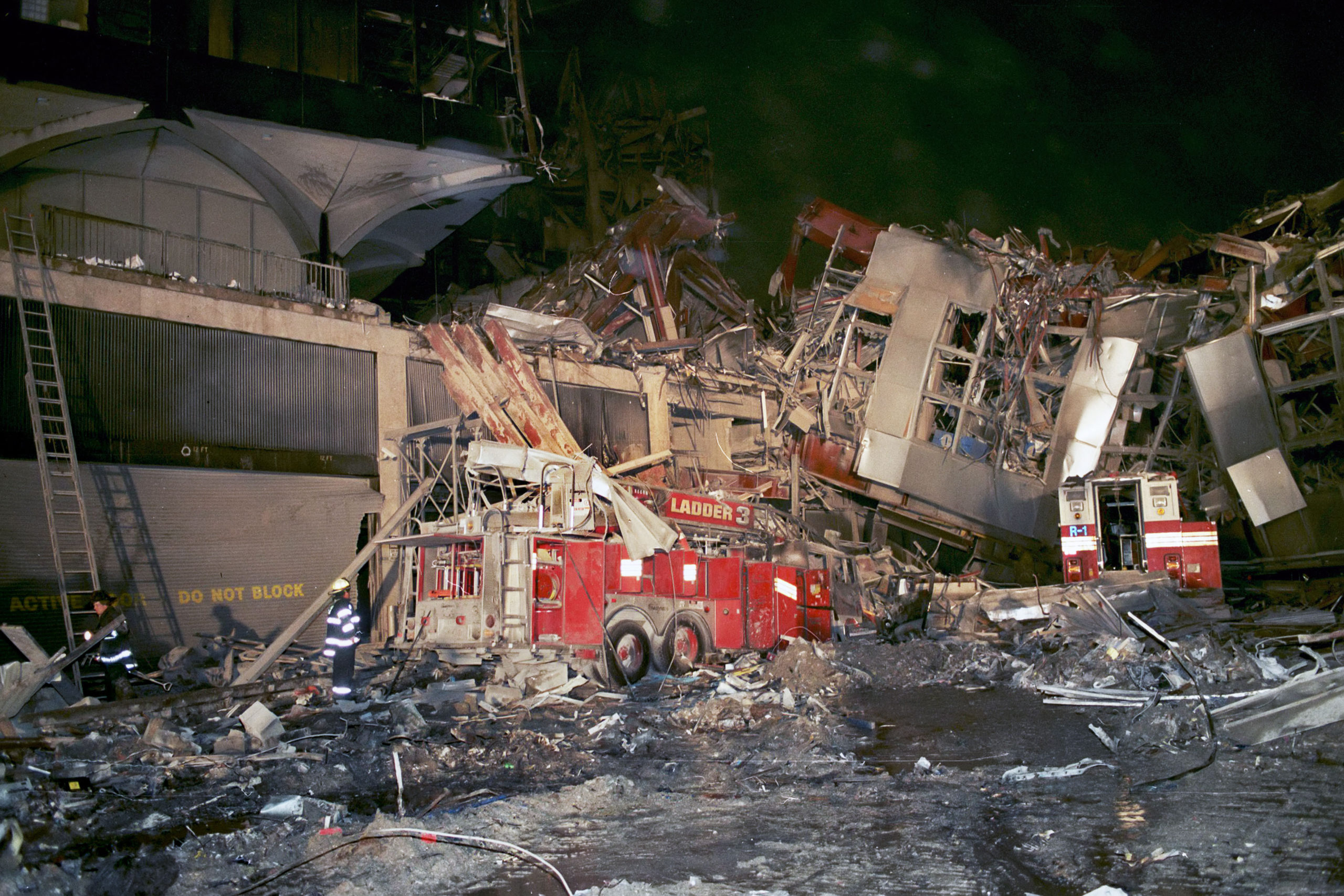 The remains of FDNY Ladder 3,FDNY Rescue 1 can also be seen at right. Photo was taken looking southeast from the main staging area at that time, which was at the intersection of West Drive and Barclay Street.   MICHAEL HELLER