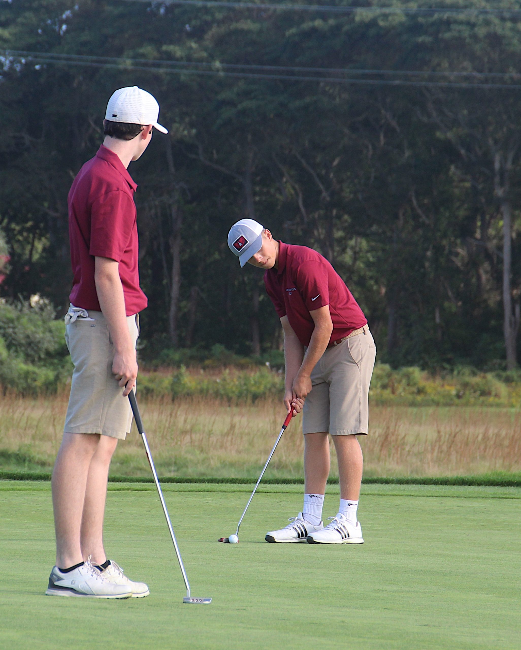 Southampton's Brian Emmons gets set to putt with teammate Liam Blackmore looking on.