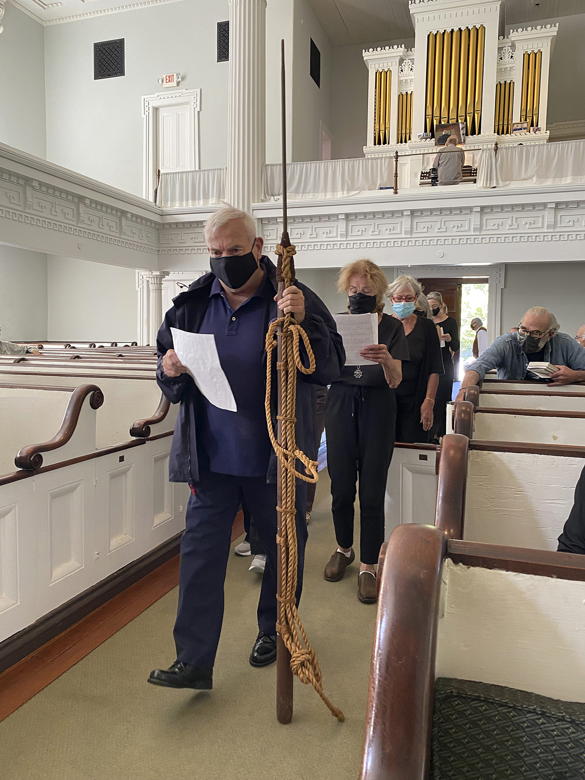 Members of the Hamptons Choral Society enter the Old Whalers Church for the Moby Dick Marathon on Friday afternoon.  DANA SHAW