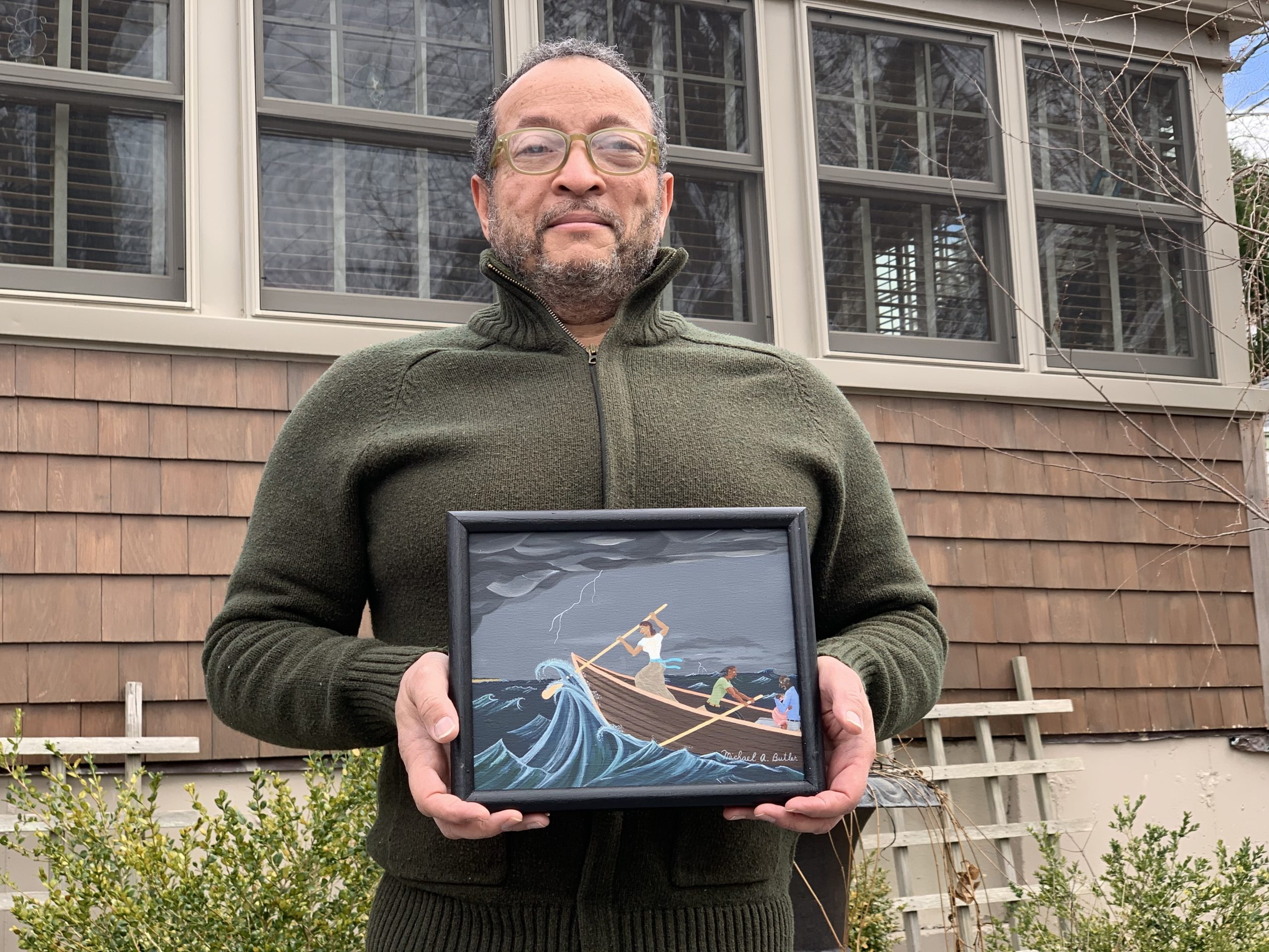 Michael A. Butler with one of his paintings.