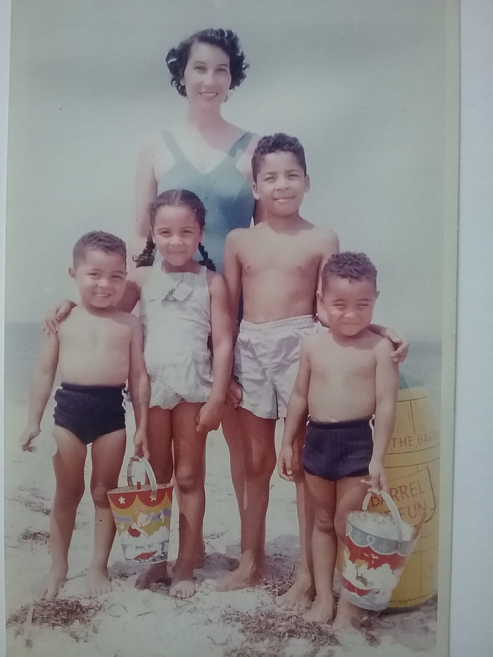 Michael A Butler with his twin brother Martin and family on a local beach.