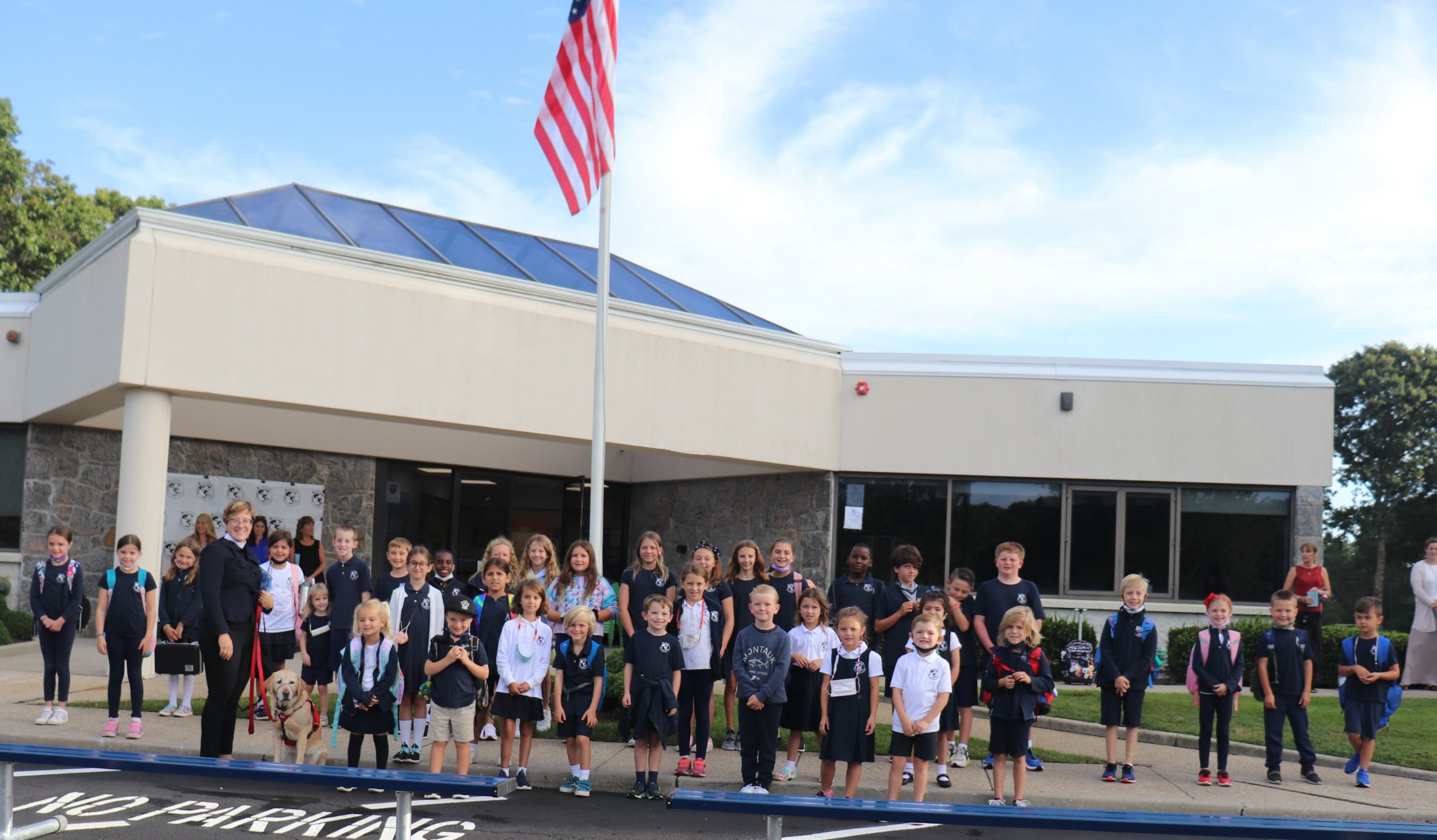 The students of Raynor Country Day School join Reverend Vanessa Winters during Raynor Country Day School's annual See You at the Pole event,  a gathering at the flagpole of school's around the globe to begin the new school year with peace and prayer.