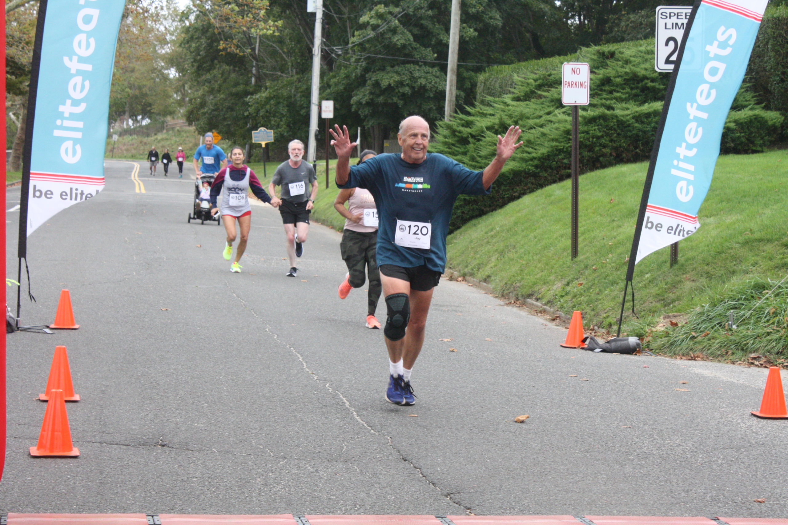 Runners cross the finish line in the Firecracker 8K on Sunday morning in Southampton Village.