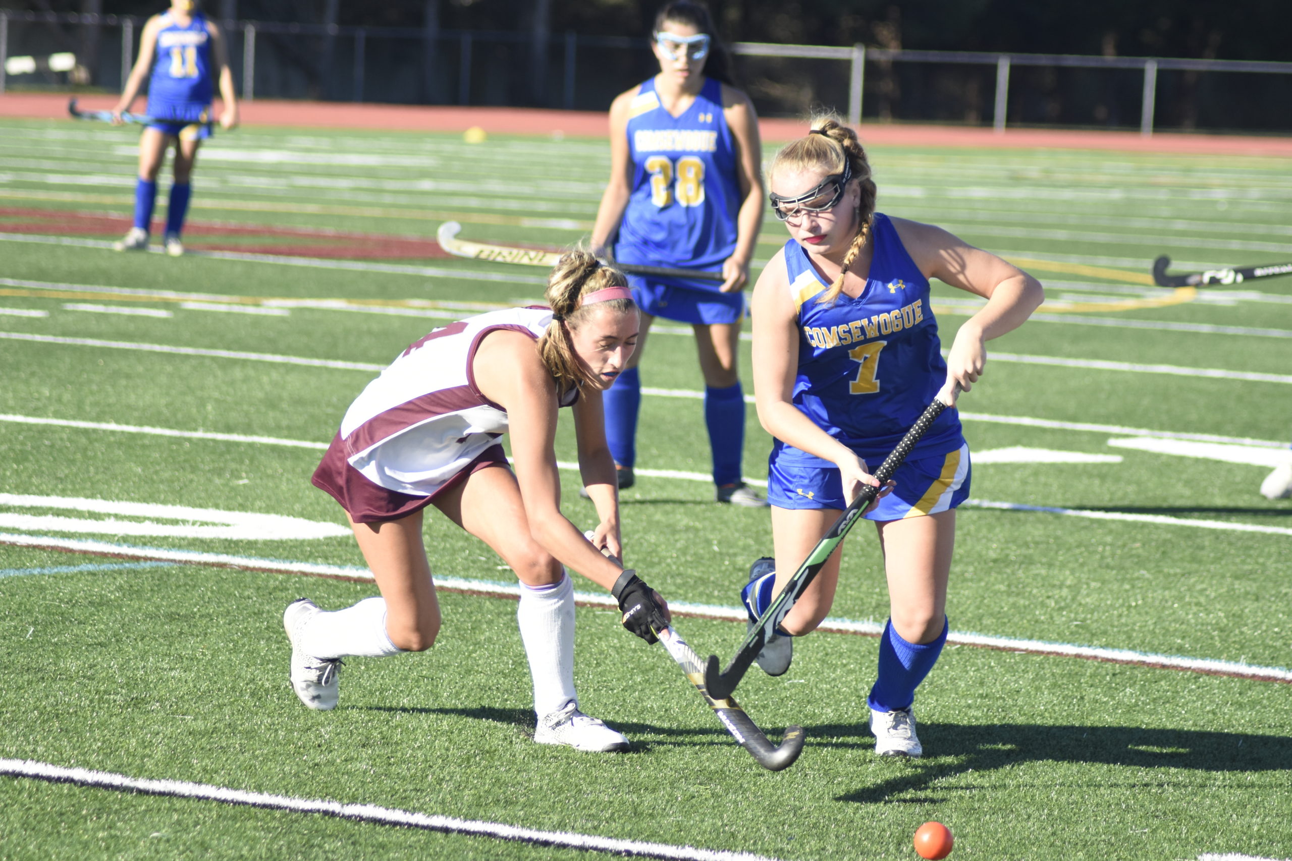 East Hampton sophomore Emma McGrory and a Comsewogue player chase down a ball off a faceoff.