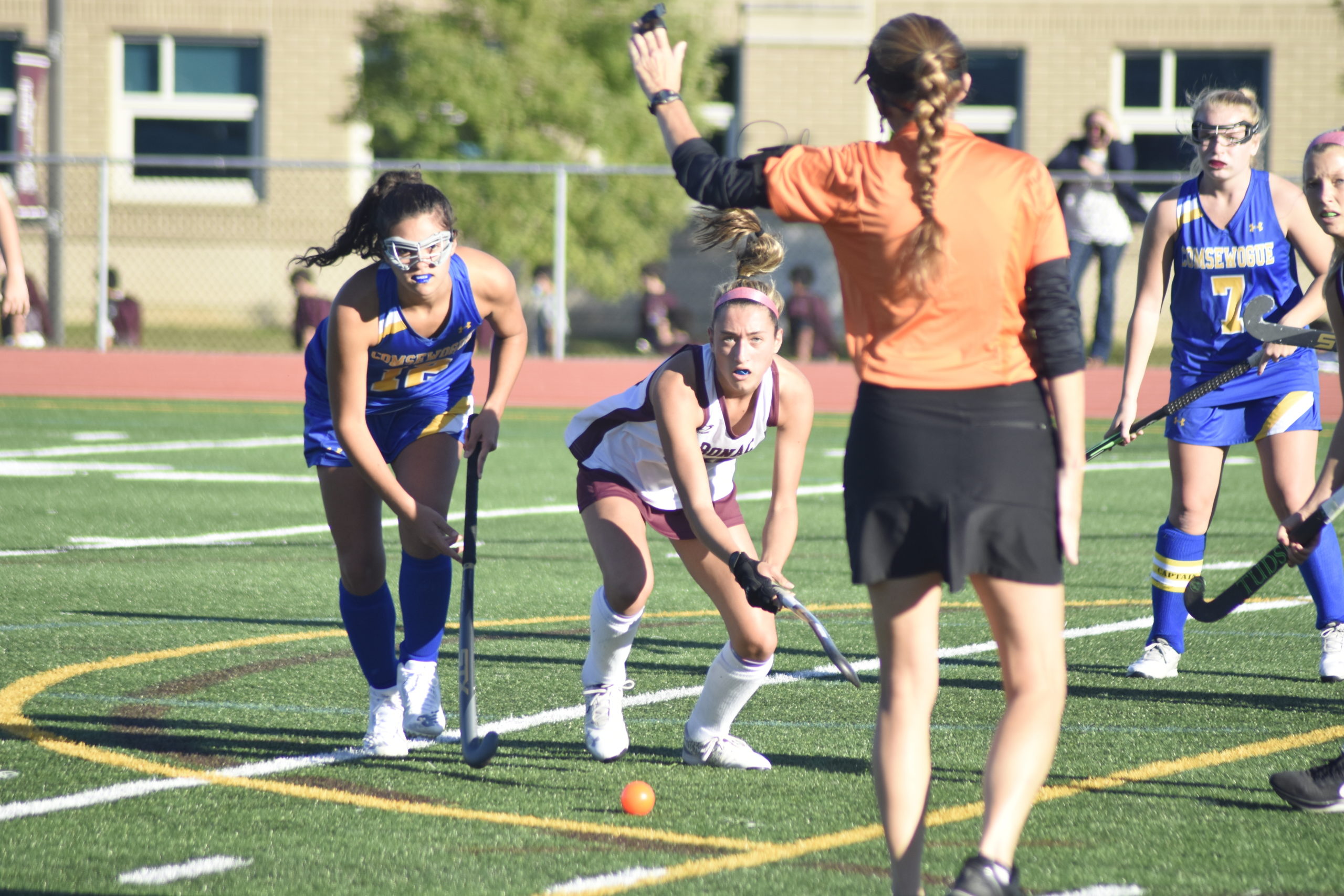 A Comsewogue player and Bonacker Emma McGrory stop play after an official's whistle.