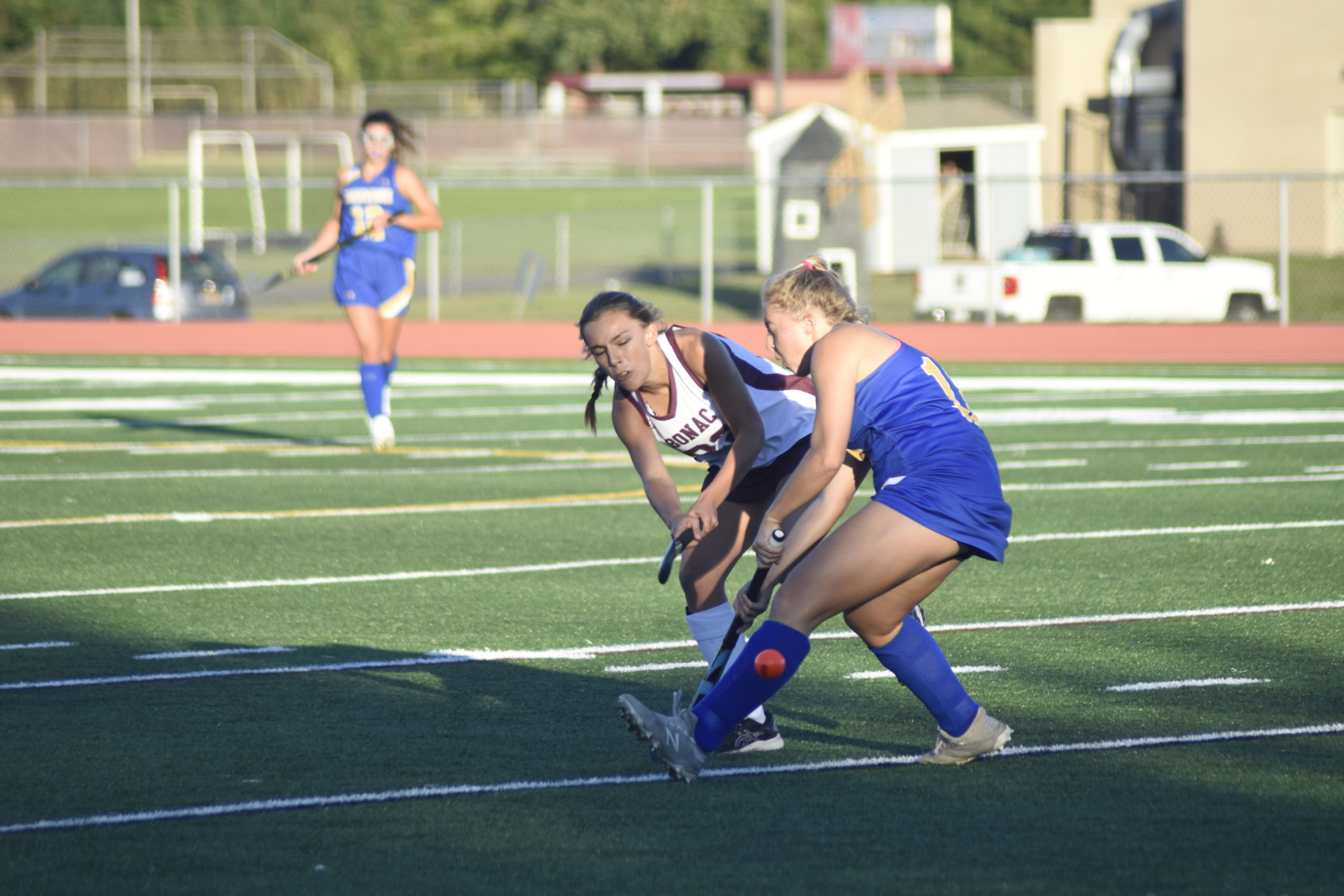 East Hampton junior Ava Arcoleo passes the ball feeling the pressure of a Comsewogue defender.