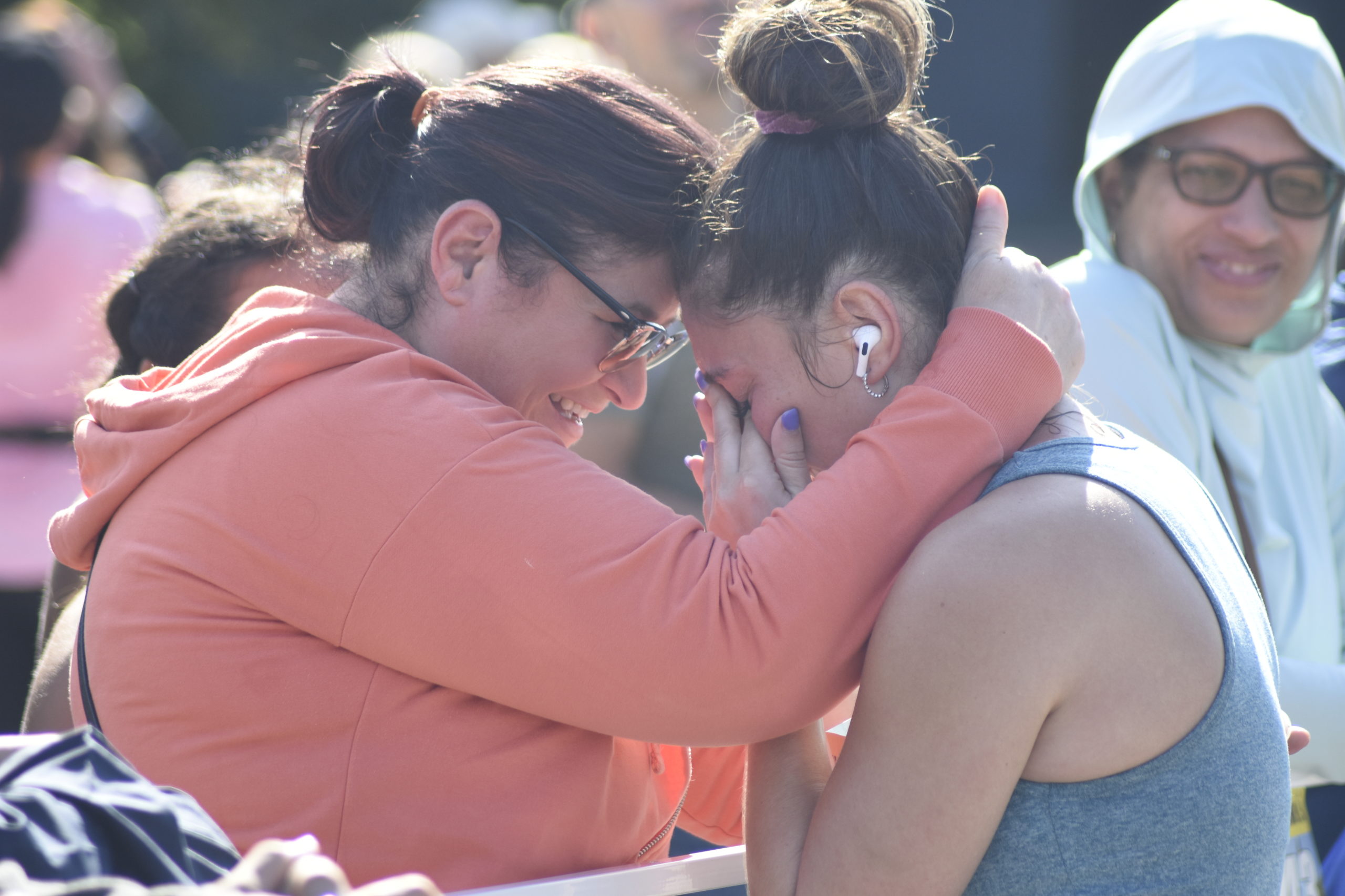 Marissa Mignano of Flushing, Queens, shares a moment with a family member after finishing the half marathon.