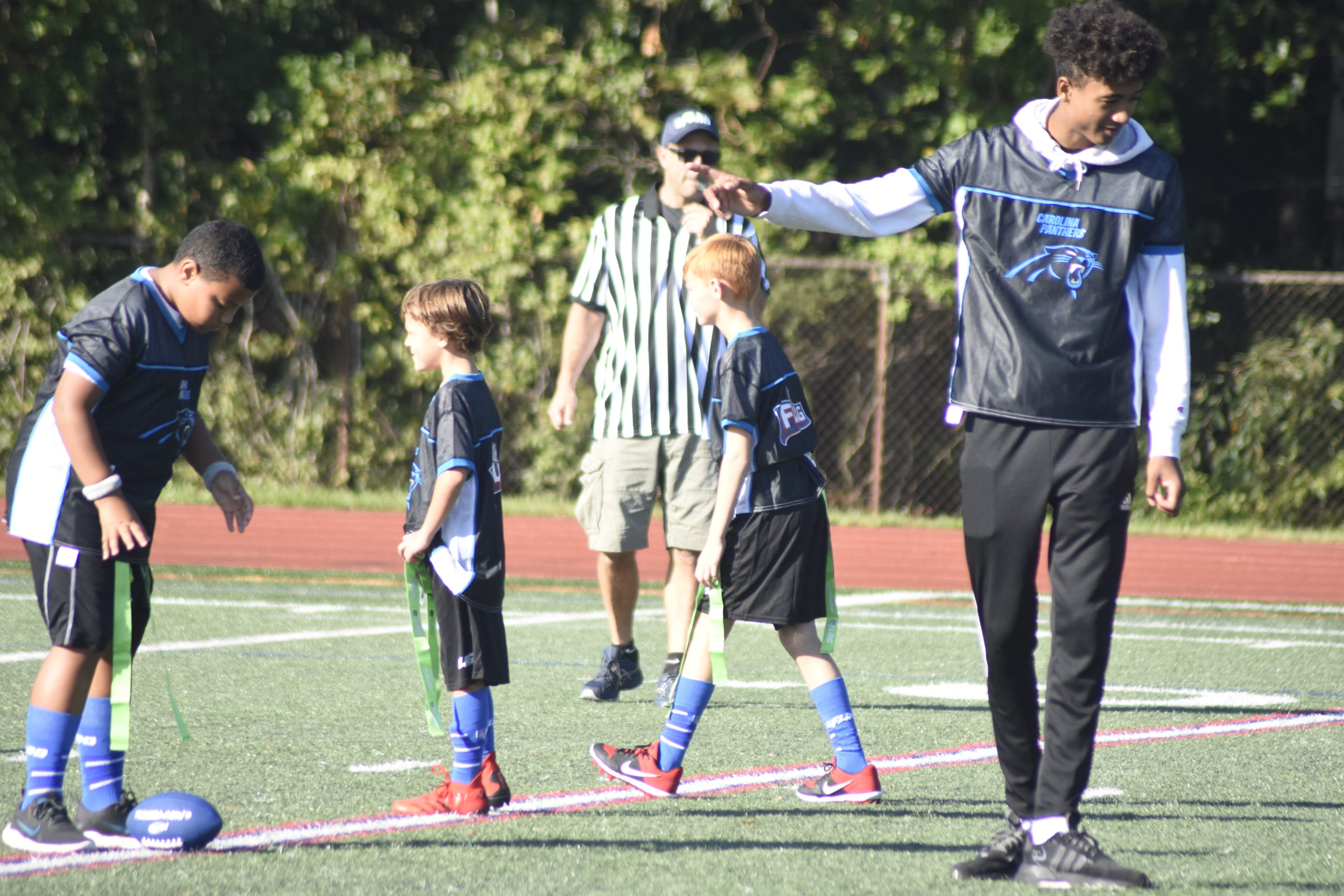 Hampton Bays High School junior Kazmin Pensa-Johnson, the starting quarterback on the Hampton Bays varsity football team, worked as one of the coaches.