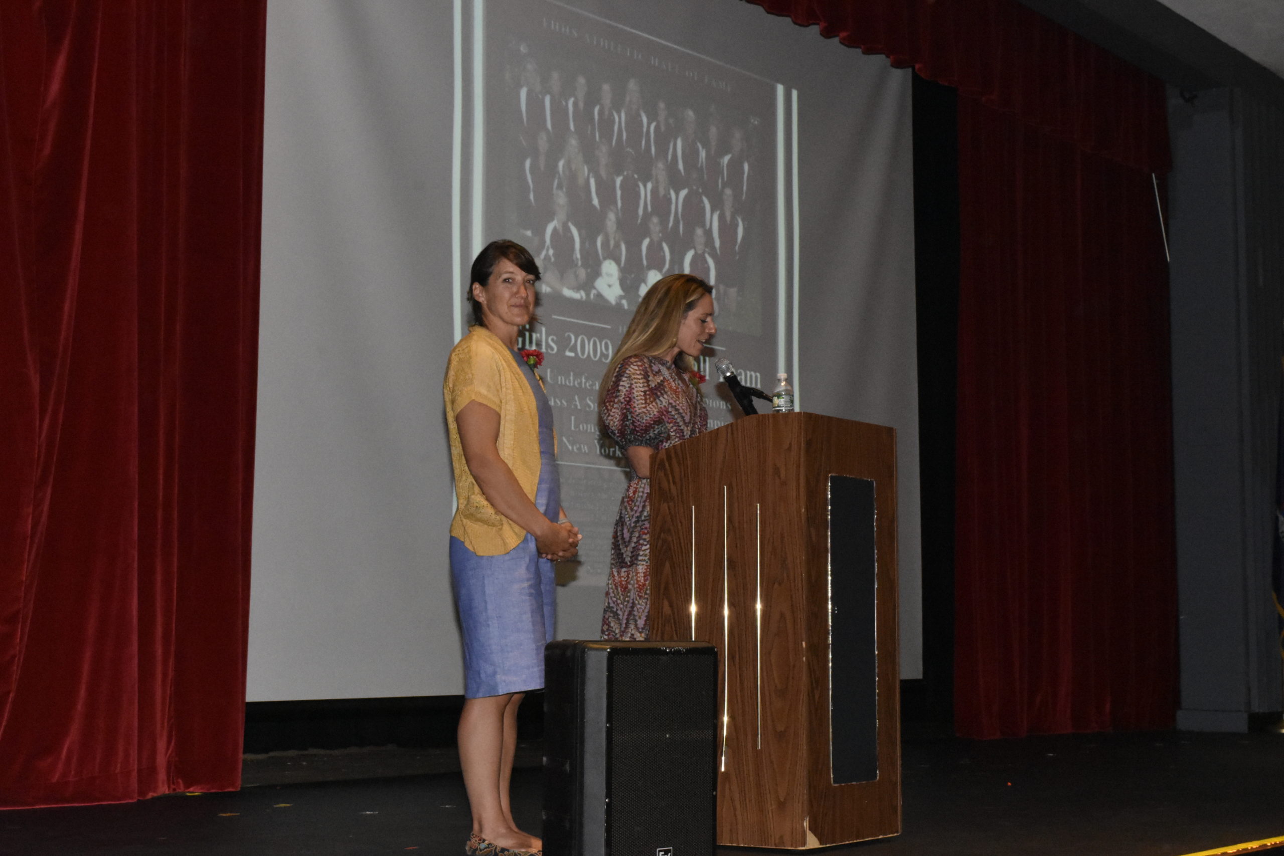 Sarah Topping, left, and Courtney Wingate introduce the 2009 girls volleyball team, one of two teams which were inducted this past weekend.