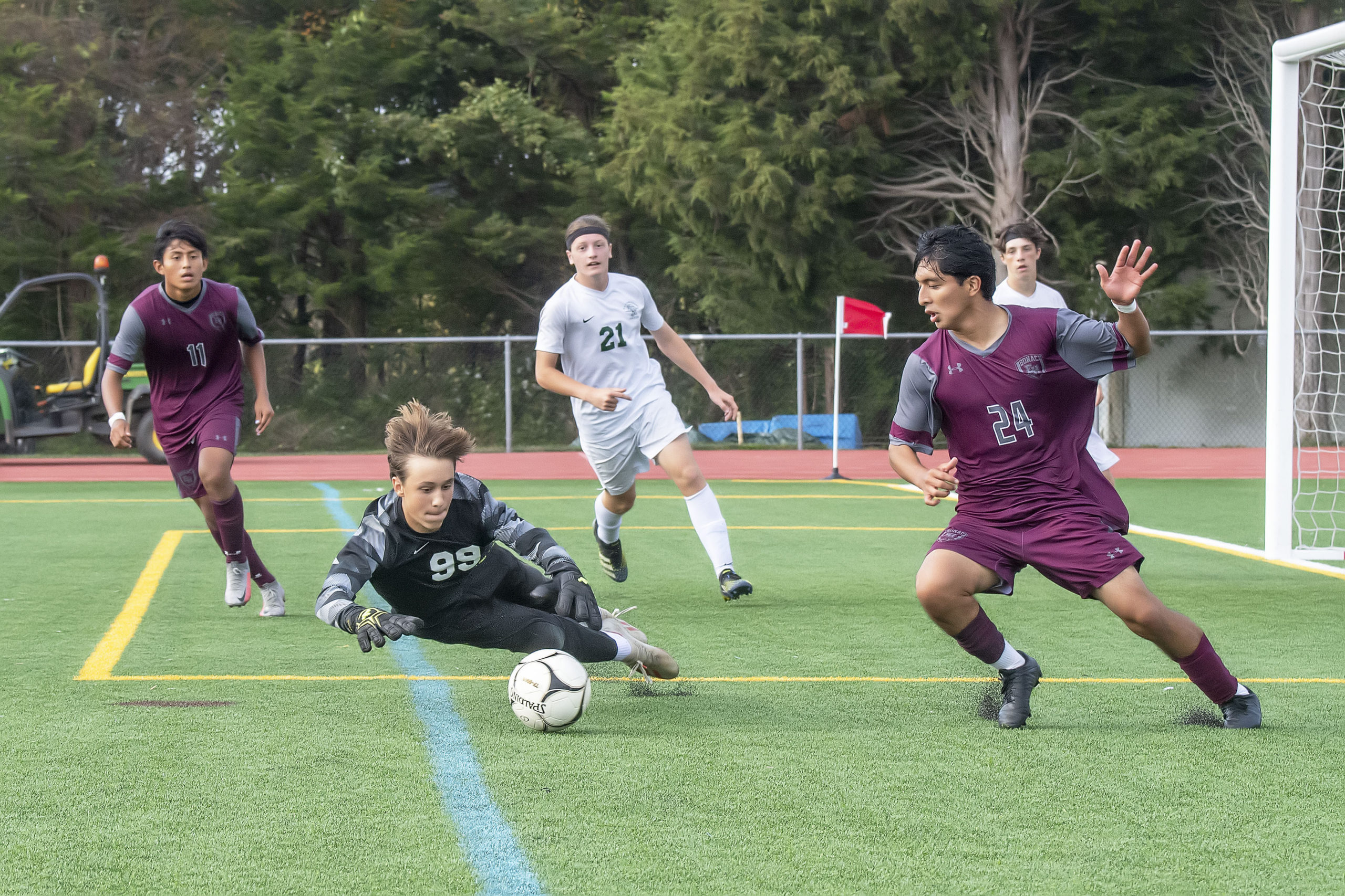 East Hampton's Gary Gutama tries to capitalize on a loose ball in front of the Harborfields goal.