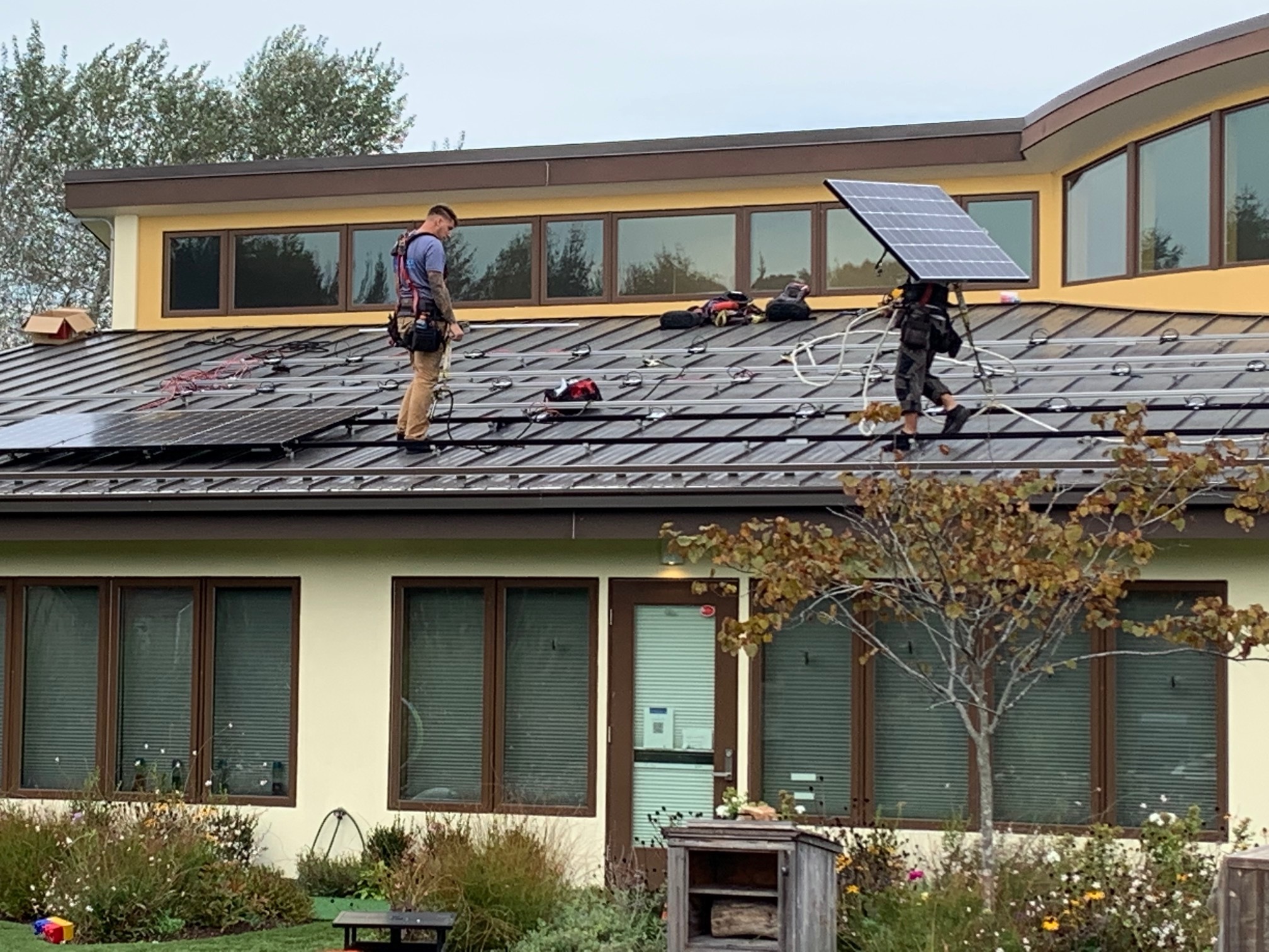 Workers install new solar panels on the roof of the Wuneechanunk Shinnecock Preschool on Monday. STEPHEN J. KOTZ