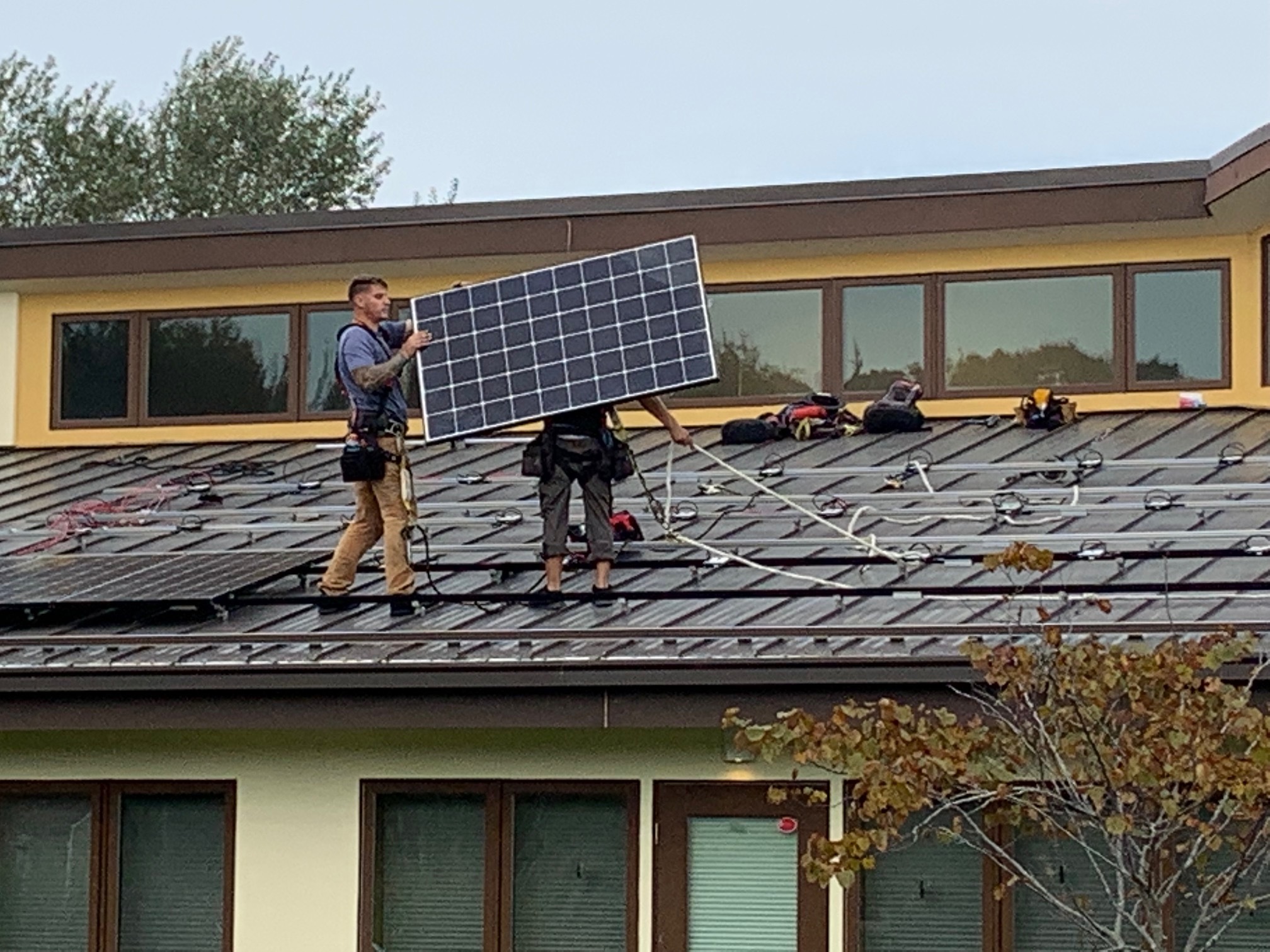 Workers install new solar panels on the roof of the Wuneechanunk Shinnecock Preschool on Monday. STEPHEN J. KOTZ