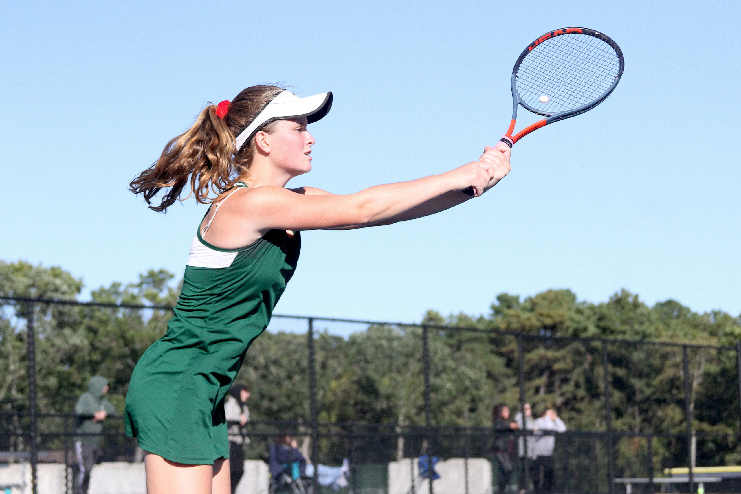 Westhampton Beach senior Katelyn Stabile reaches for the ball at the net for the final point in the Division IV doubles final win over William Floyd. DESIRÉE KEEGAN