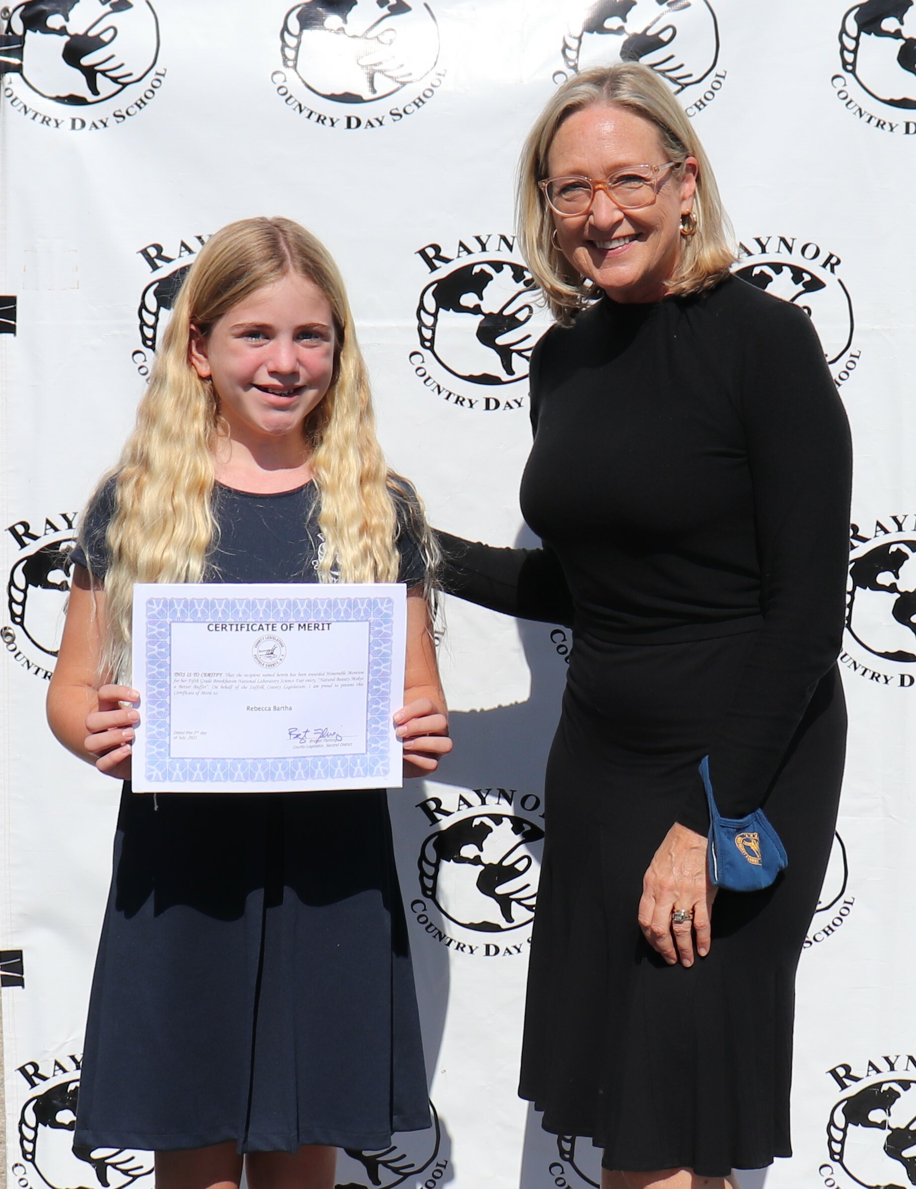 Suffolk County Legislator Bridget Fleming visited Raynor Country Day School last Friday, during which she presented student Rebecca Bartha with a certificate for her first-place and/or honorable mention in science contests at the Brookhaven National Lab over the last six  years.  Rebecca's projects continue to target a scientific approach to local environmental problems.