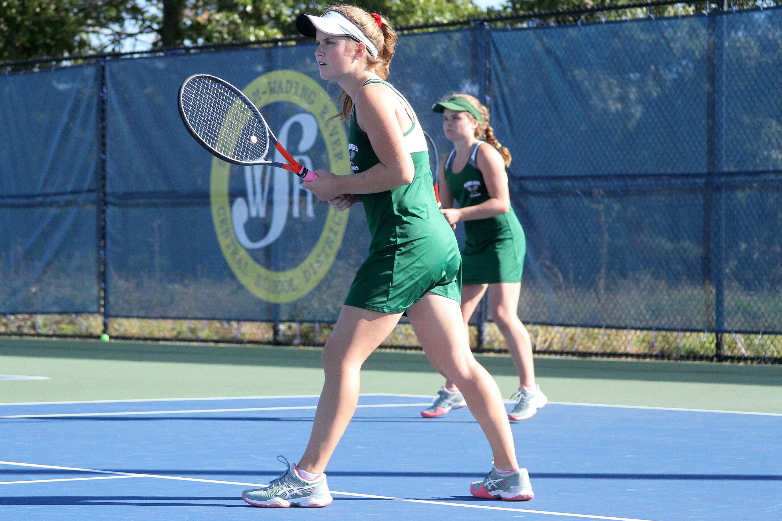 Westhampton Beach senior Katelyn Stabile and younger sister Julia a sophomore, ready themselves for a William Floyd serve. DESIRÉE KEEGAN