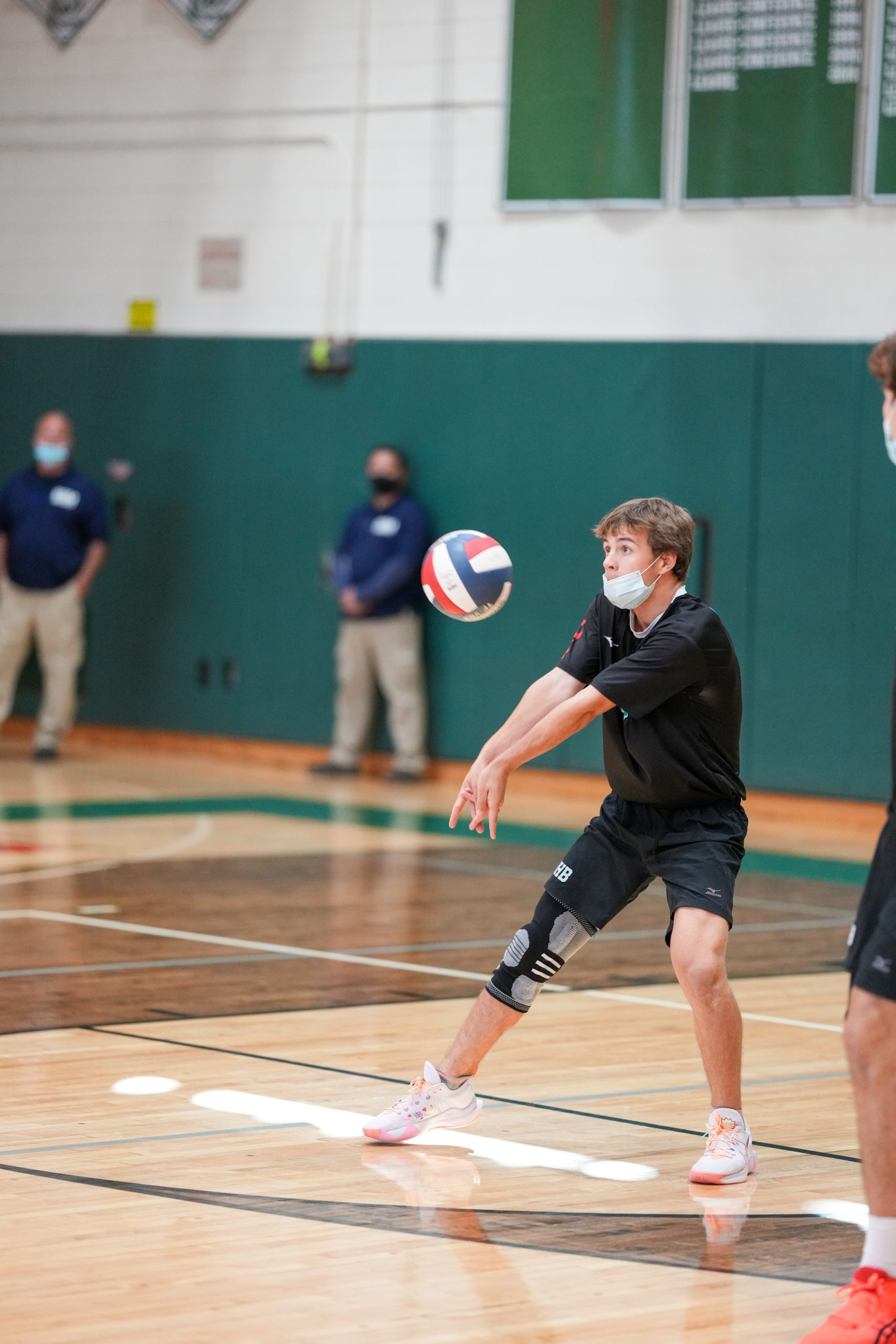 A Westhampton Beach player returns a serve.