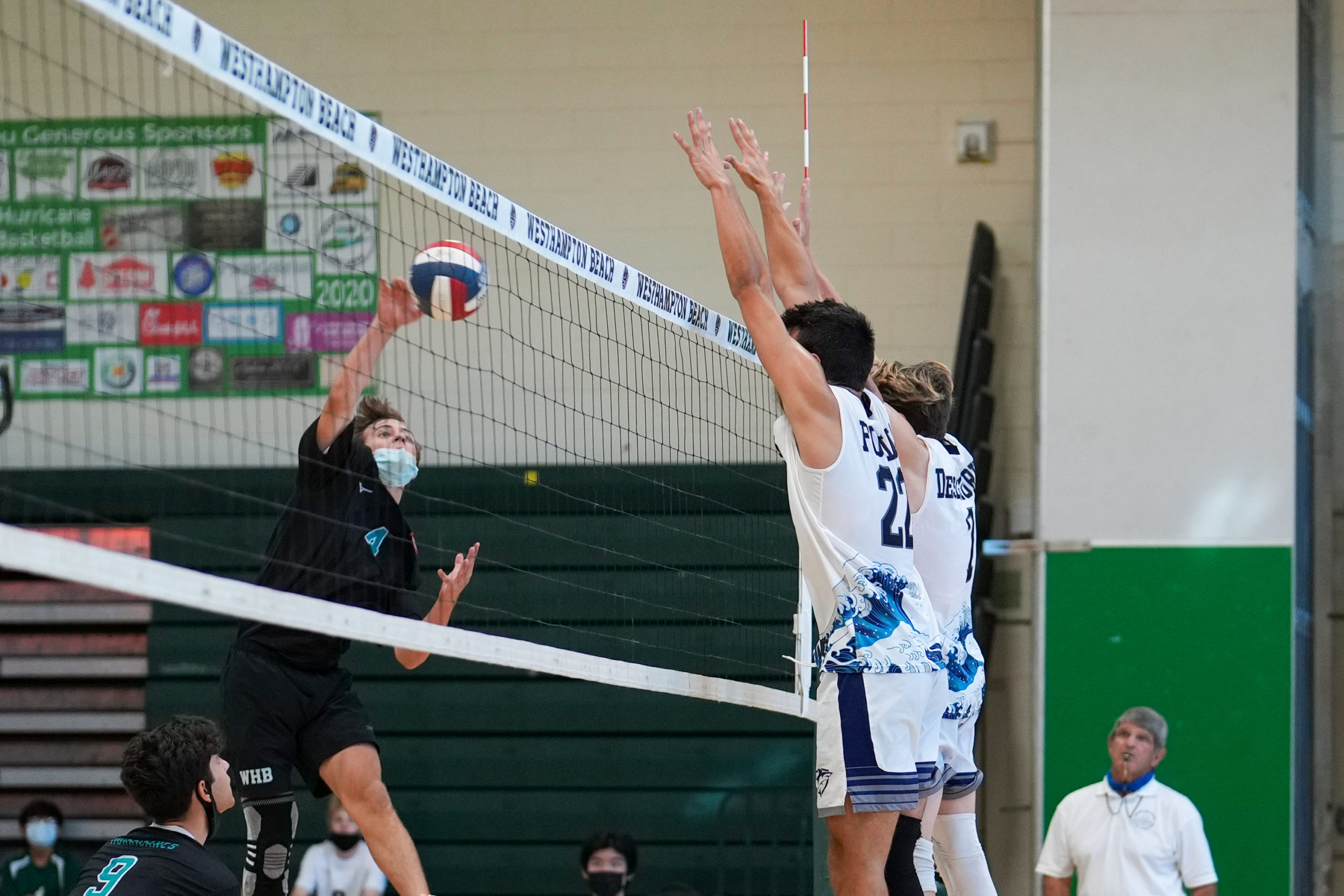 Westhampton Beach sophomore outside hitter Seth Terry spikes the ball.