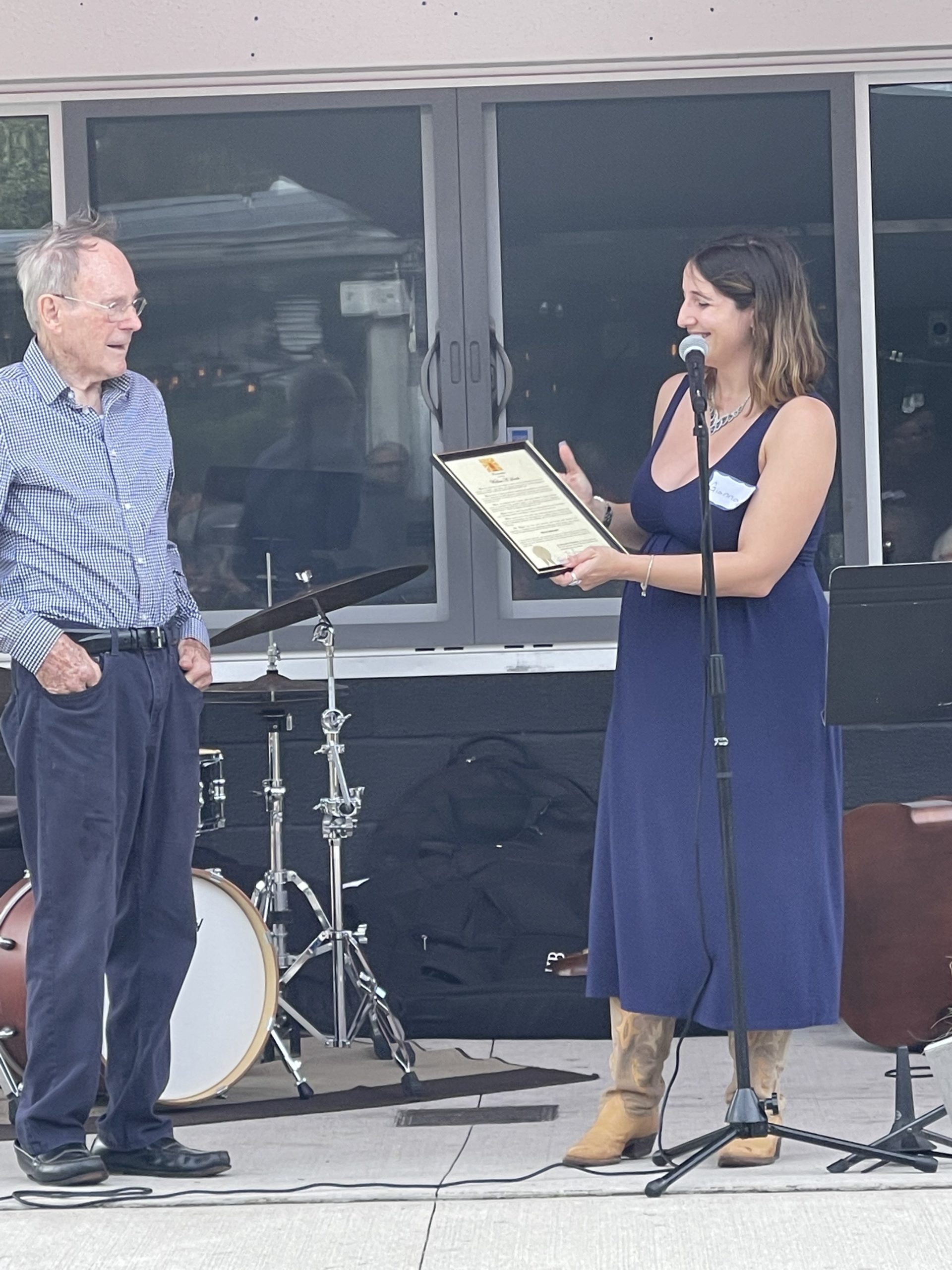 Gianna Volpe presents Wally Smith with a proclamation.