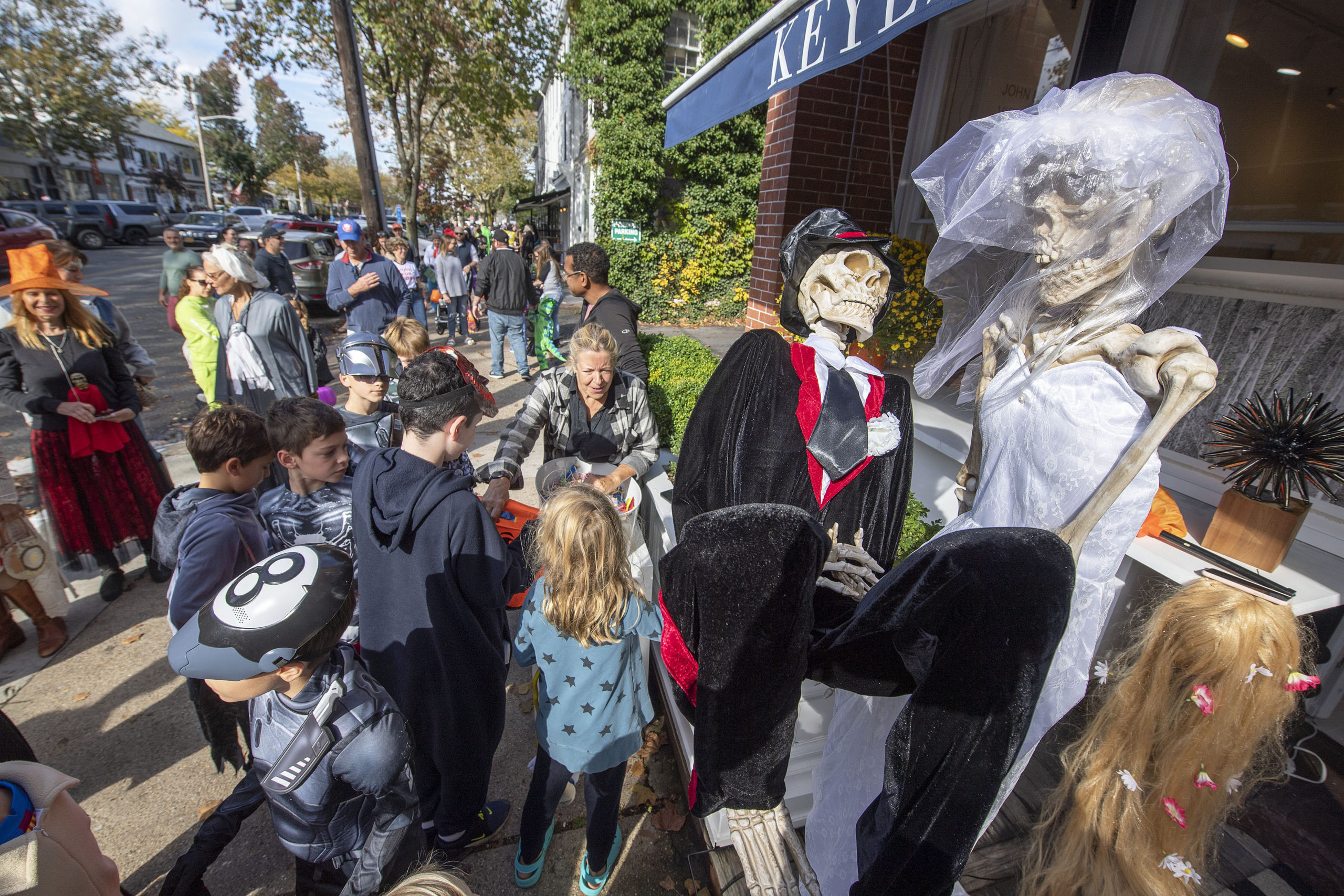 Julie Keyes hands out candy during the 2021 Sag Harbor Pumpkin Trail on Halloween Day, October 31.   MICHAEL HELLER