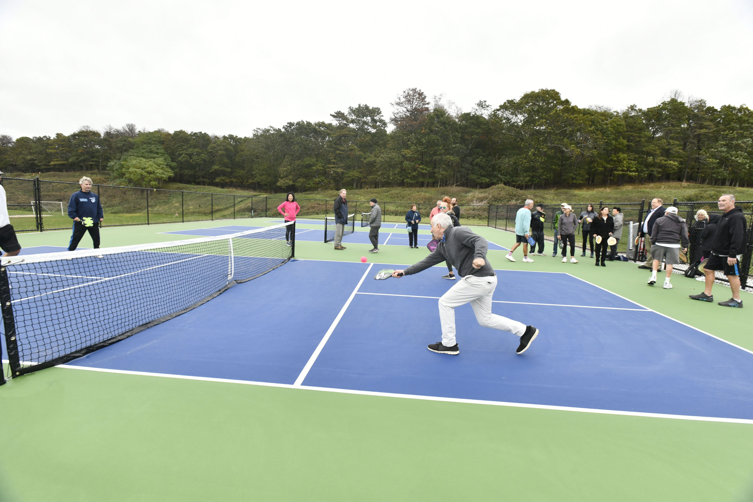 Southampton Town Supervisor Jay Schneiderman tries out the new pickleball courts.  DANA SHAW