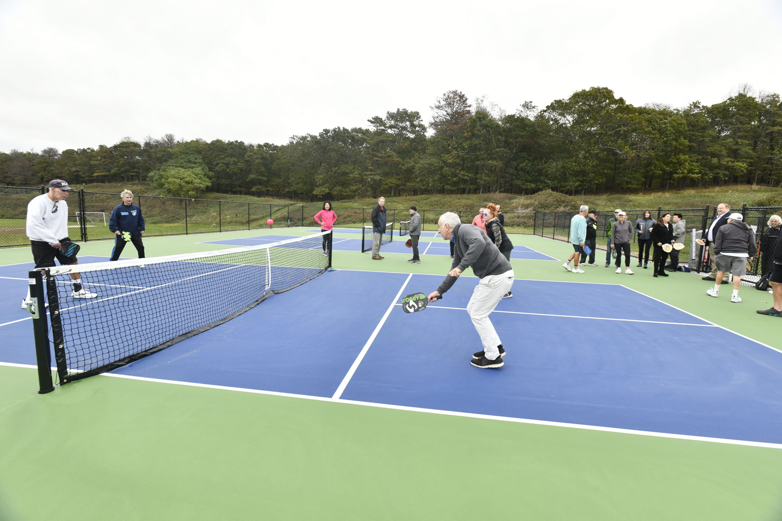 Southampton Town Supervisor Jay Schneiderman tries out the new pickleball courts.   DANA SHAW