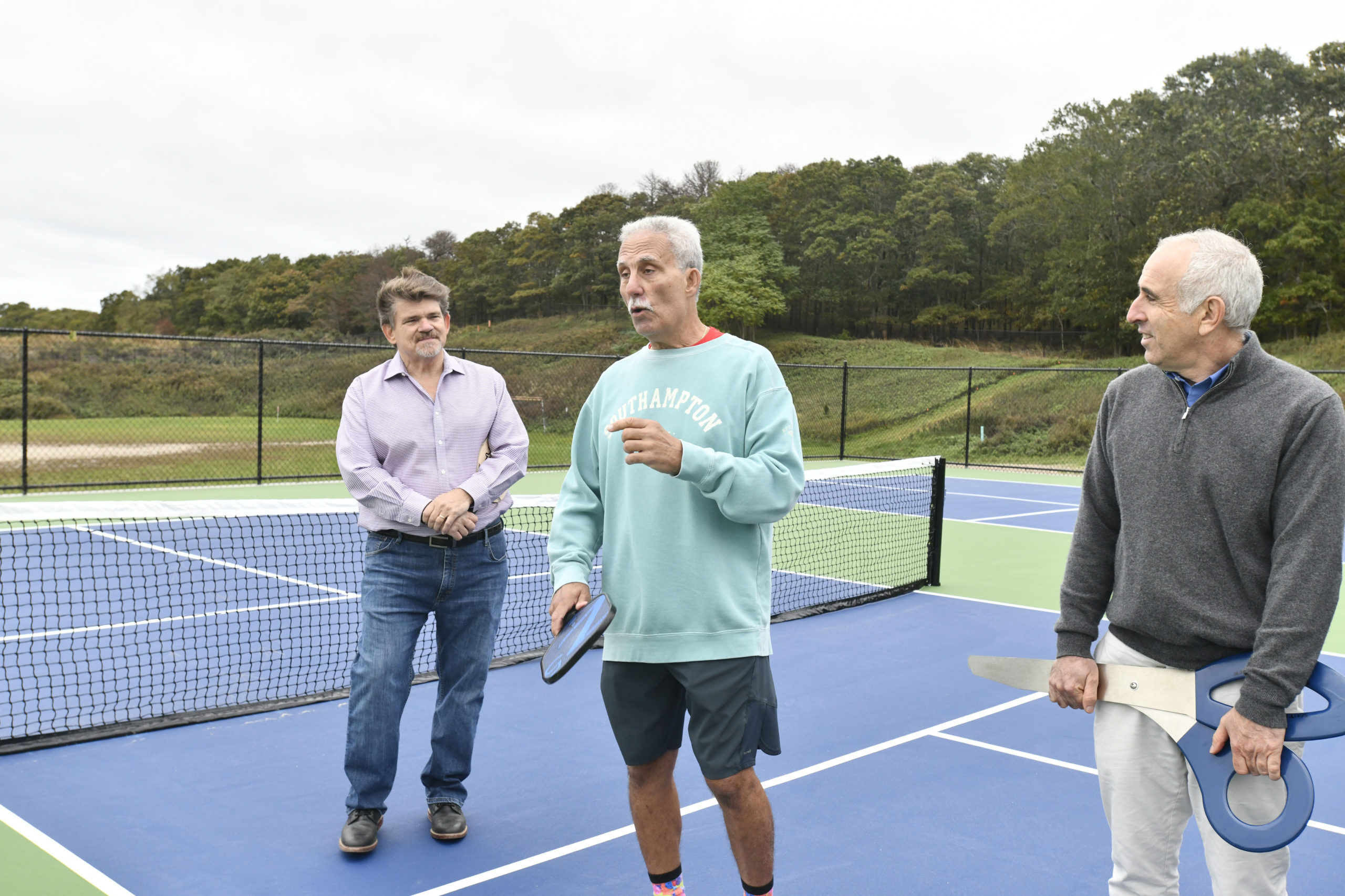 Southampton Town Board member Tommy John Schiavoni, Vinnie Mangano and Town Supervisor Jay Schneiderman at the new pickleball courts at North Sea Community Park.  DANA SHAW