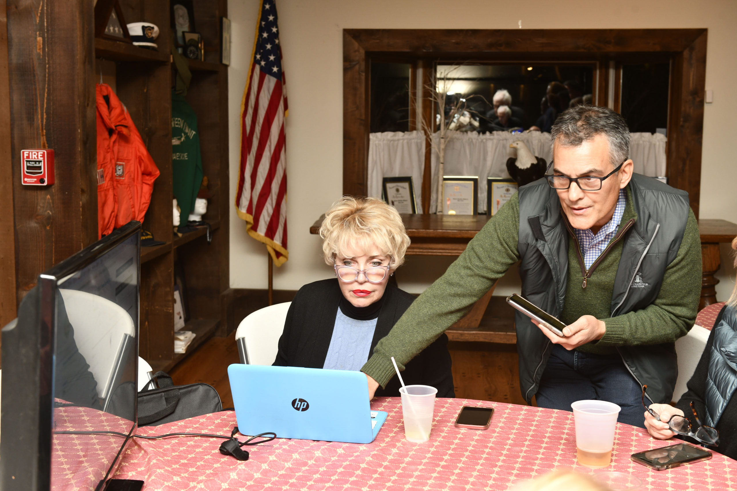 Ann Thomas and Bill Parash watch as election results come in.  DANA SHAW