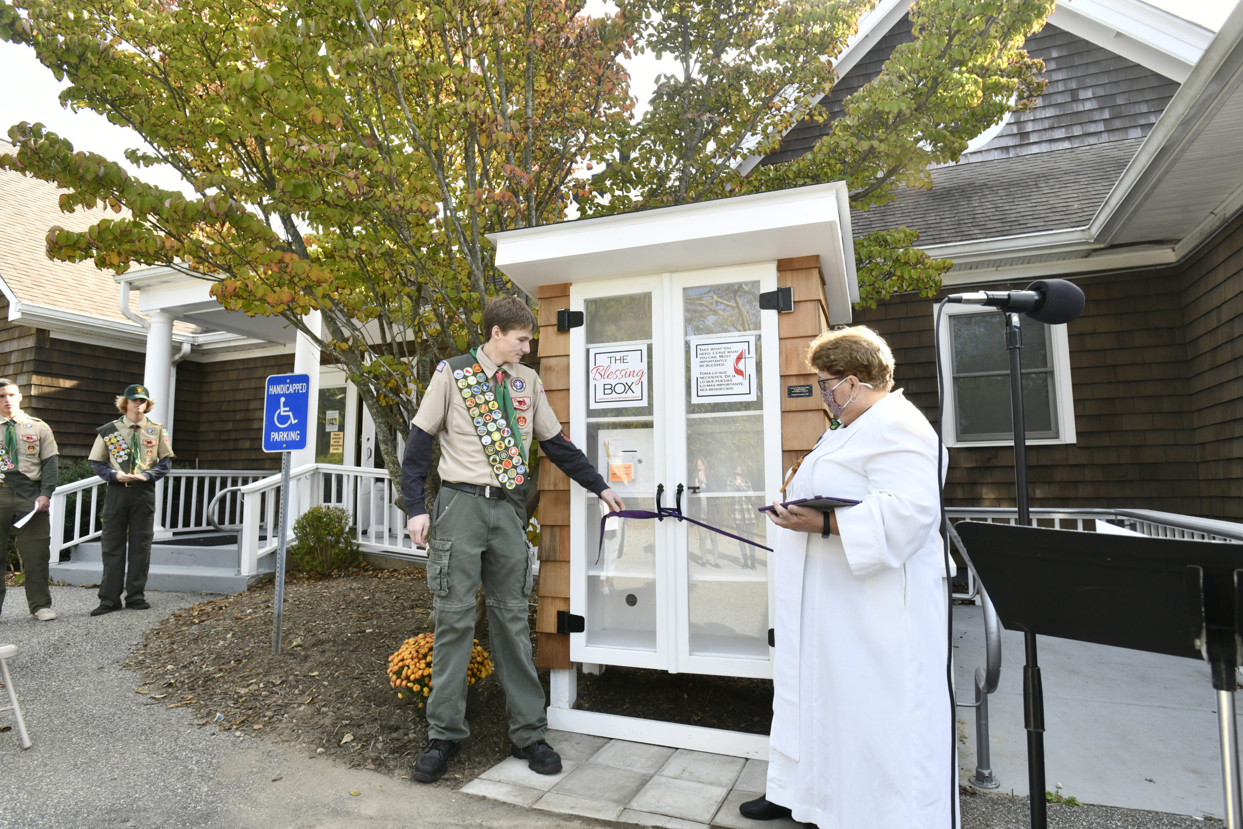 Eagle Scout Jagger Maddock and Rev. Joanne  Utley, open  the new “Blessing Box,” micro food pantry on Sunday at the Hamptons United Methodist Church in Southampton. Jagger Maddock constructed the “micro food pantry” as an Eagle Scout project, with the help of the leaders and other scouts of Troop 58.   DANA SHAW