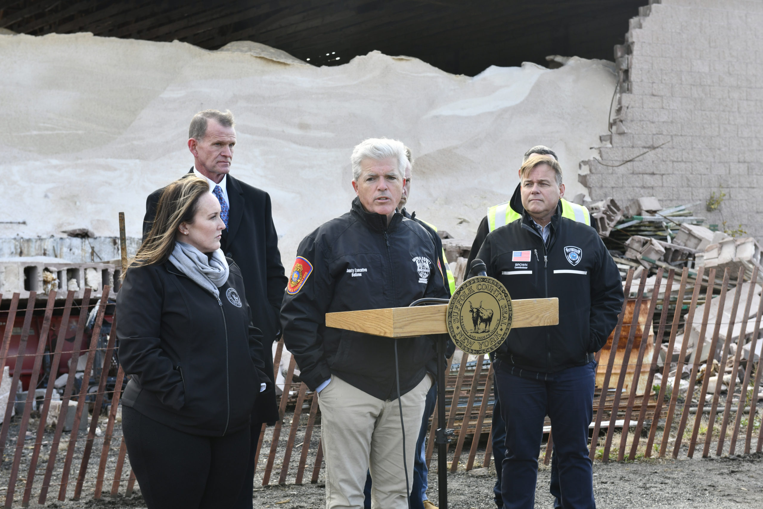 Suffolk County Executive Steve Bellone, along with Chief Deputy County Executive Lisa Black; Stuart Cameron, Acting Commissioner, Suffolk County Police Department; Patrick Beckley, Acting Commissioner, Suffolk County Department of Fire, Rescue and Emergency Services; Joe Brown, Commissioner, Suffolk County Department of Public Works and Ray Muxo, Suffolk County DPW Construction Engineer, PE  at the Suffolk County DPW yard and salt barn in Westhampton on Monday which sustained significant damage from a confirmed tornado on Saturday leaving it structurally unsound.      DANA SHAW