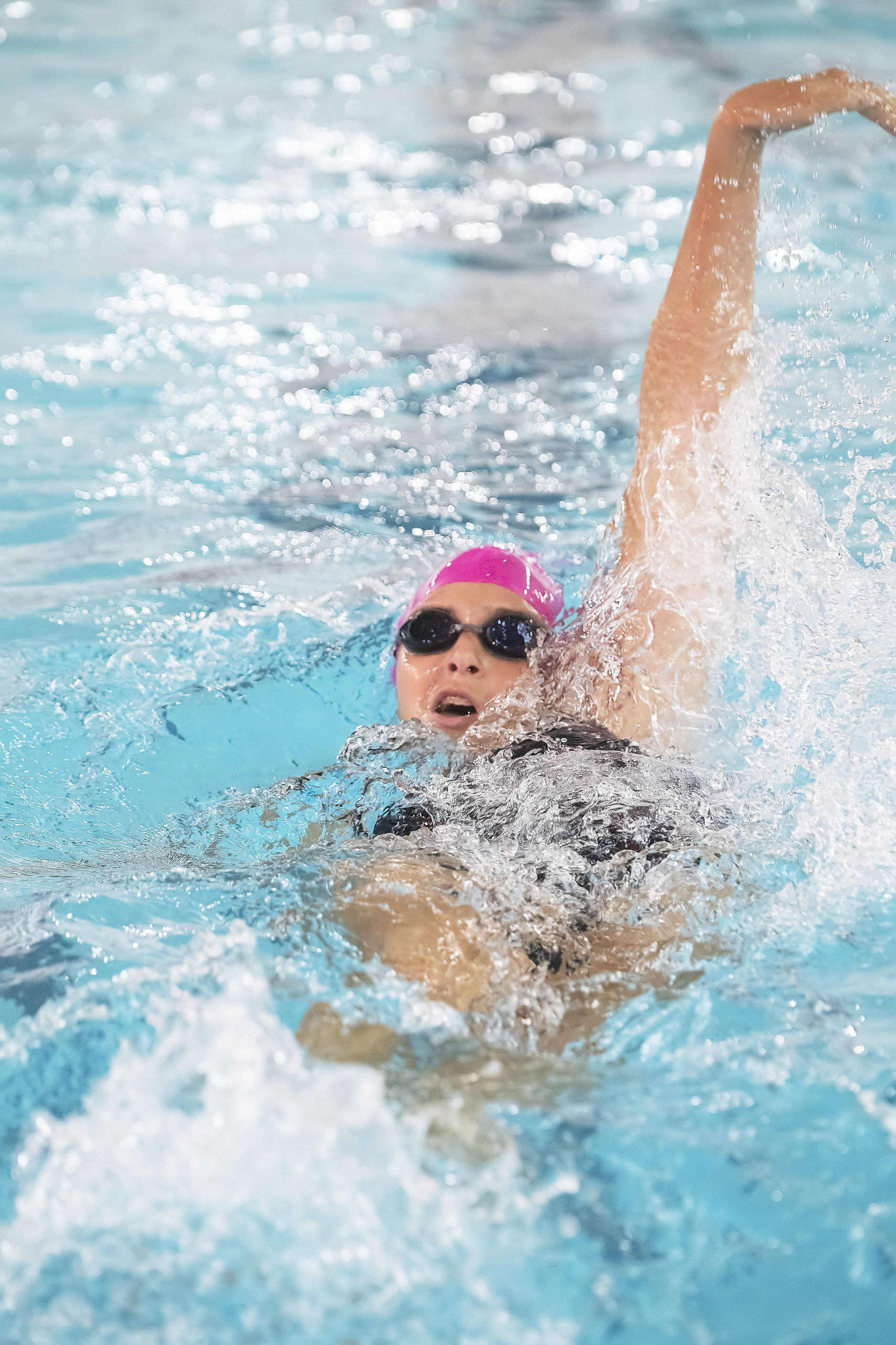 East Hampton's Camryn Hatch in the 100-yard backstroke in a meet earlier this season. Hatch qualified for states in both the backstroke and 100-yard freestyle this past weekend.