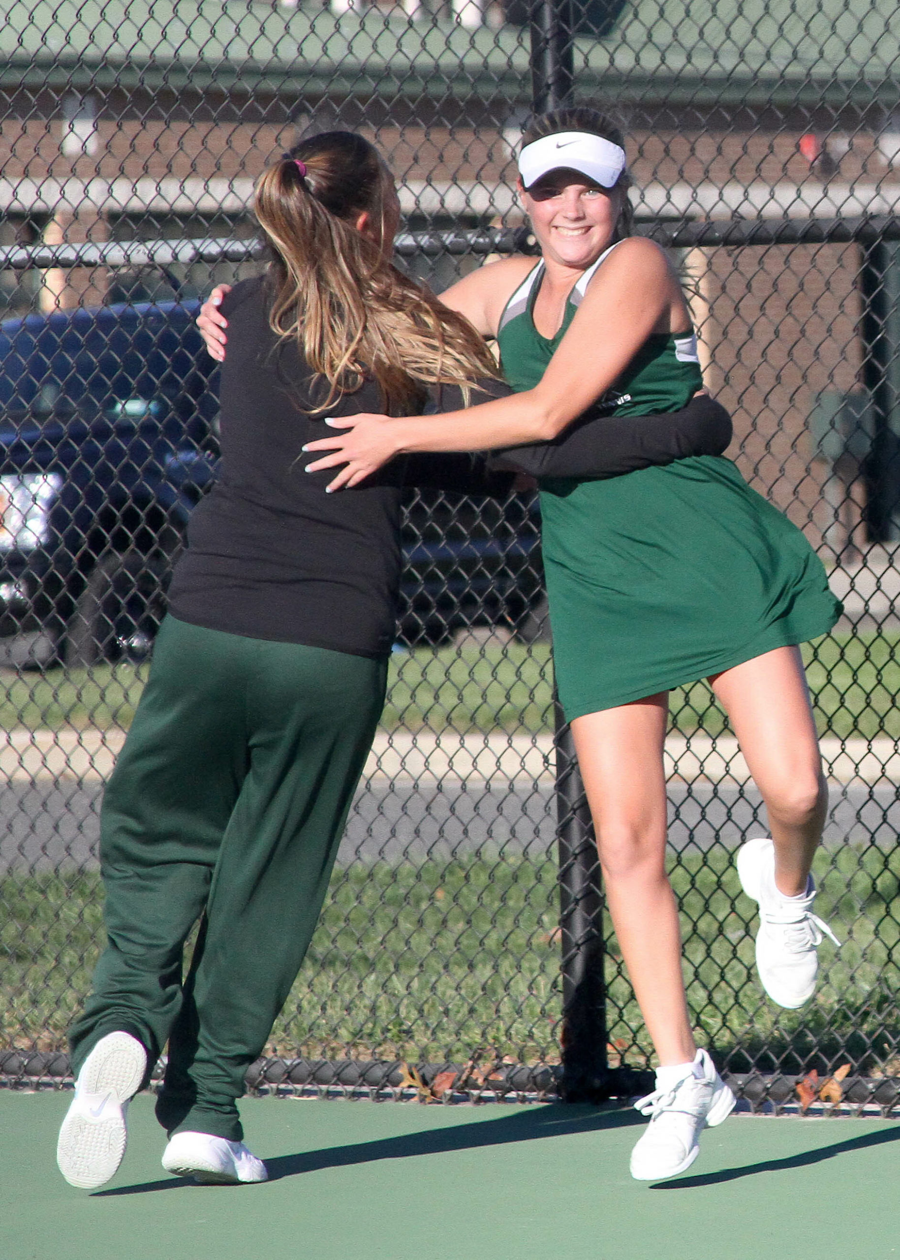 Westhampton Beach senior Emma Way is embraced by classmate Alexandra Sielaw after her match-clinching victory at No. 4 singles. DESIRÉE KEEGAN