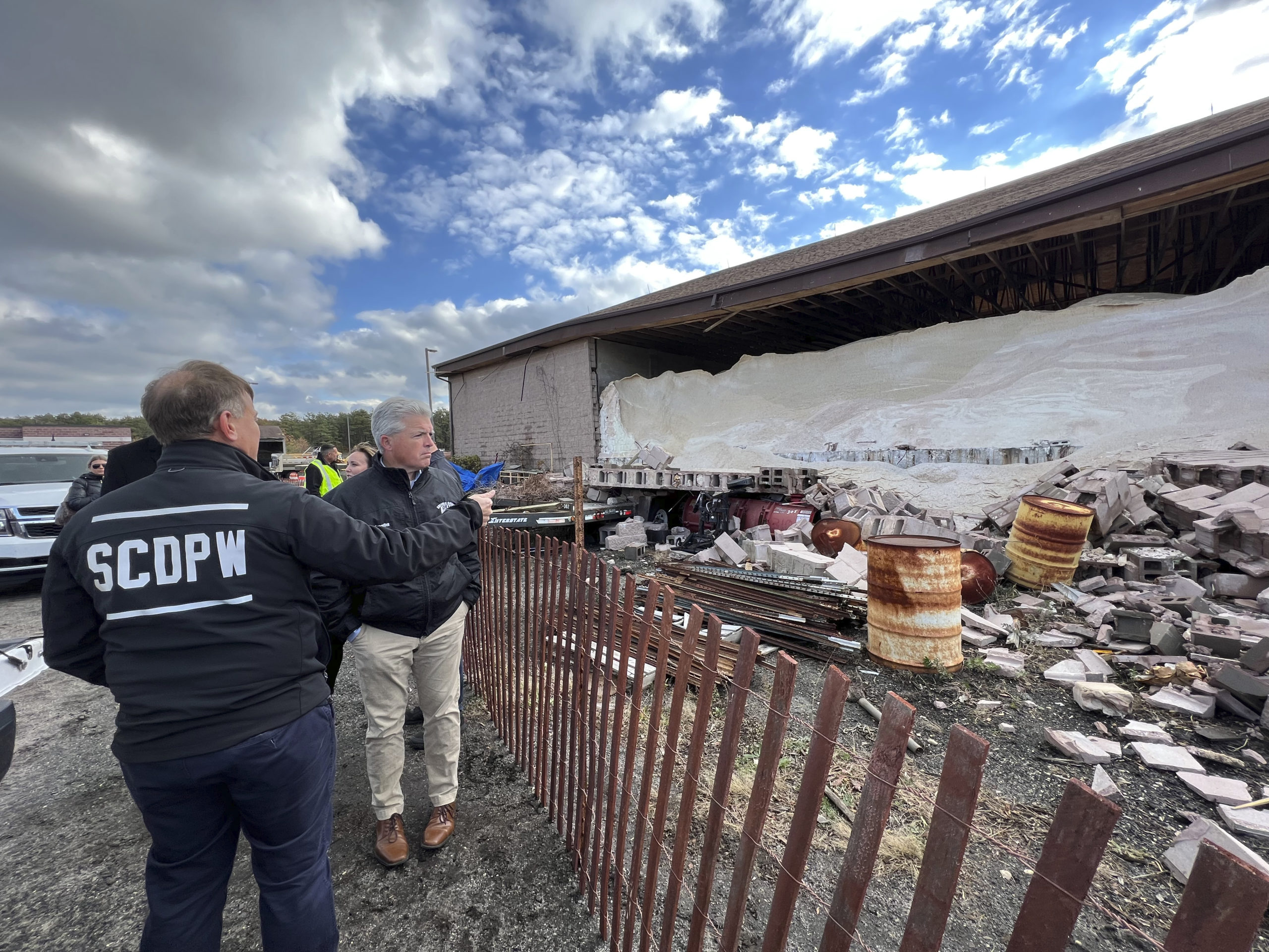 Suffolk County Executive Steve Bellone surveys the damage at the Suffolk County DPW yard and salt barn in Westhampton which sustained significant damage from a confirmed tornado on Saturday leaving it structurally unsound.      DANA SHAW