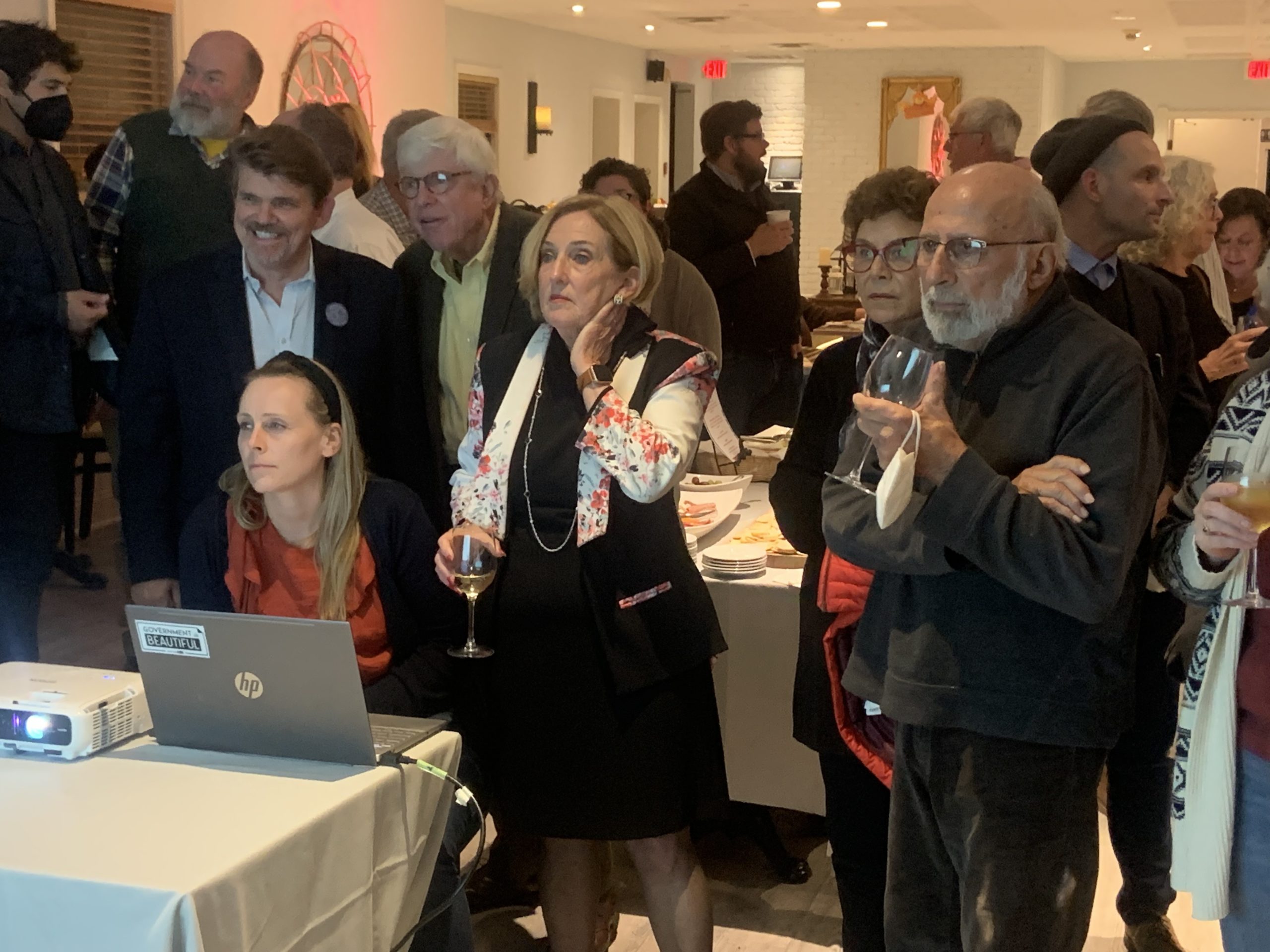 Democrats, including Town Board candidates Tommy John Schiavoni, left, and Robin Long, center, watch as  results are tabulated Tuesday night. STEPHEN J. KOTZ