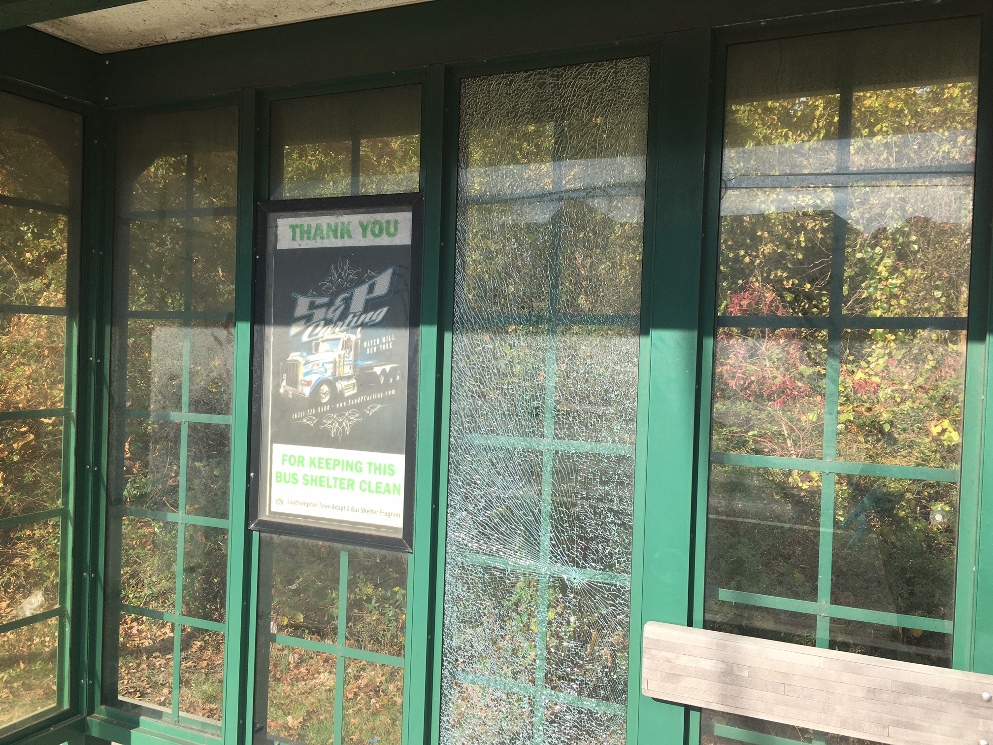 One glass panel is webbed with cracks at the bus shelter near Shrubland Road on County Road 39 in Southampton.