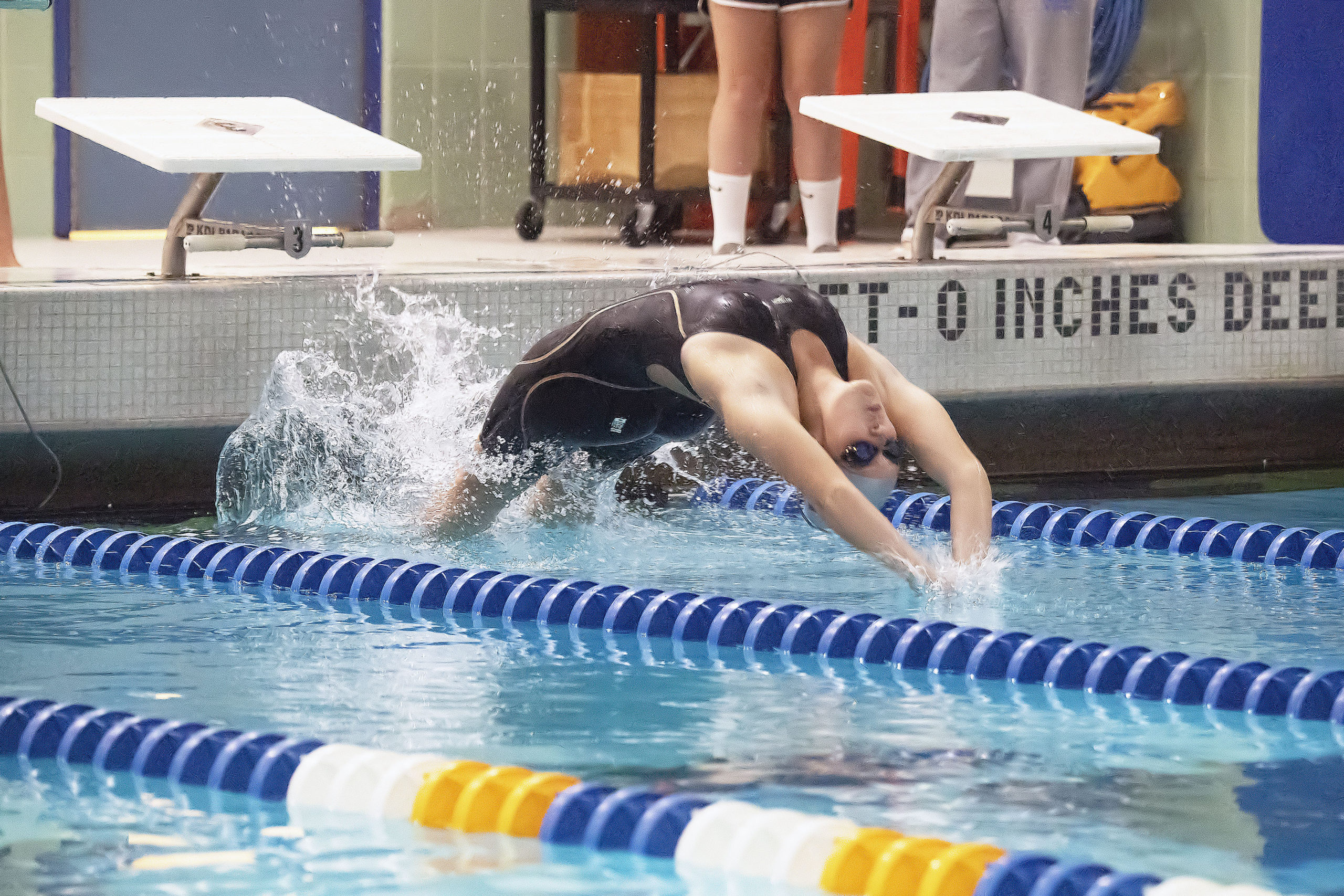 East Hampton's Camryn Hatch launches herself into a backstroke as she races in the first leg of the 200-yard medley relay during the  League III Championships at West Islip High School on October 27.