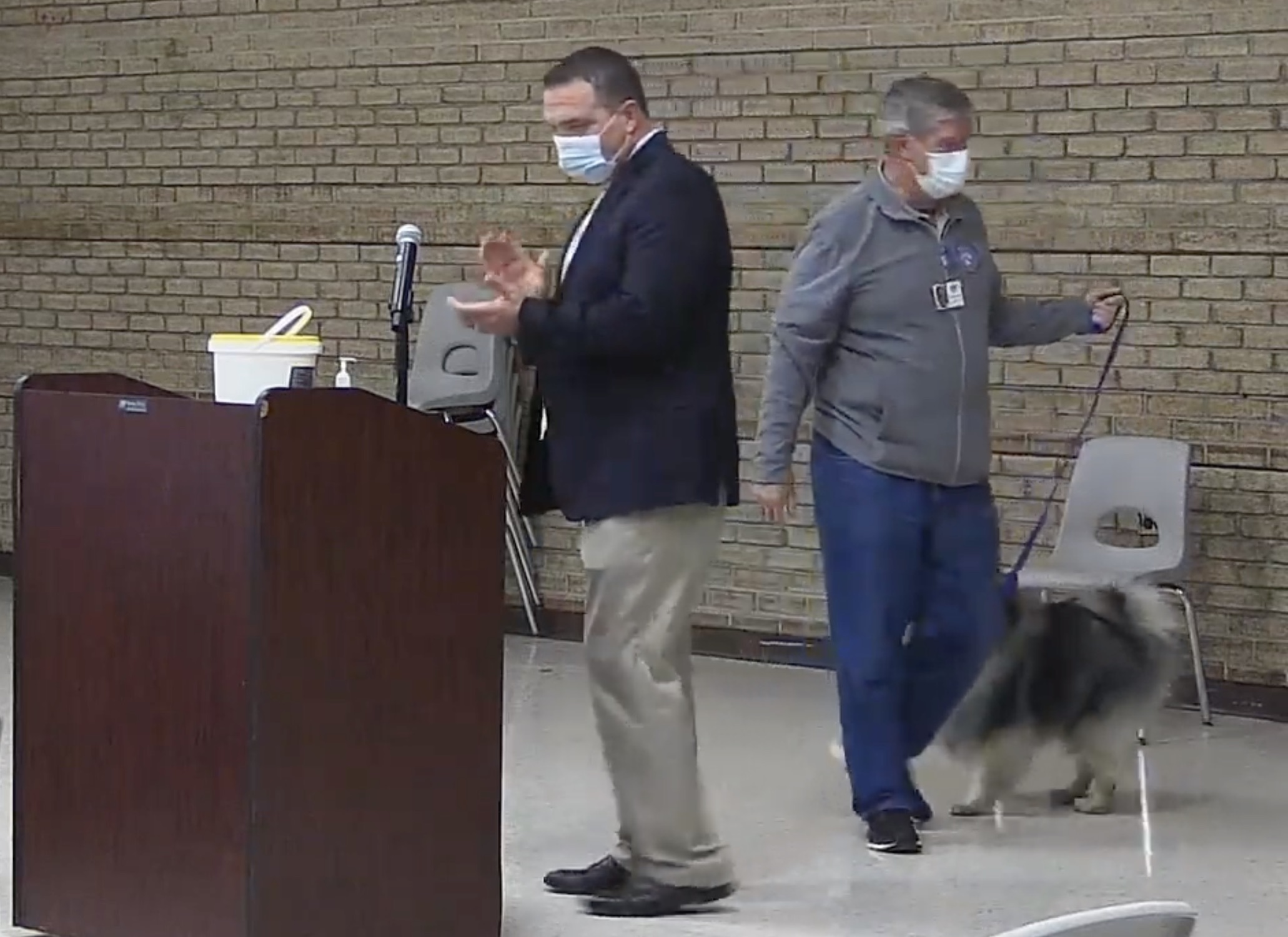 Hampton Bays Assistant Superintendent for Curriculum, Instruction & Assessment Michael Carlson introduces Love on a Leash volunteer Bob Lynch and his dog Ray to the district during the November 9 board of education meeting.