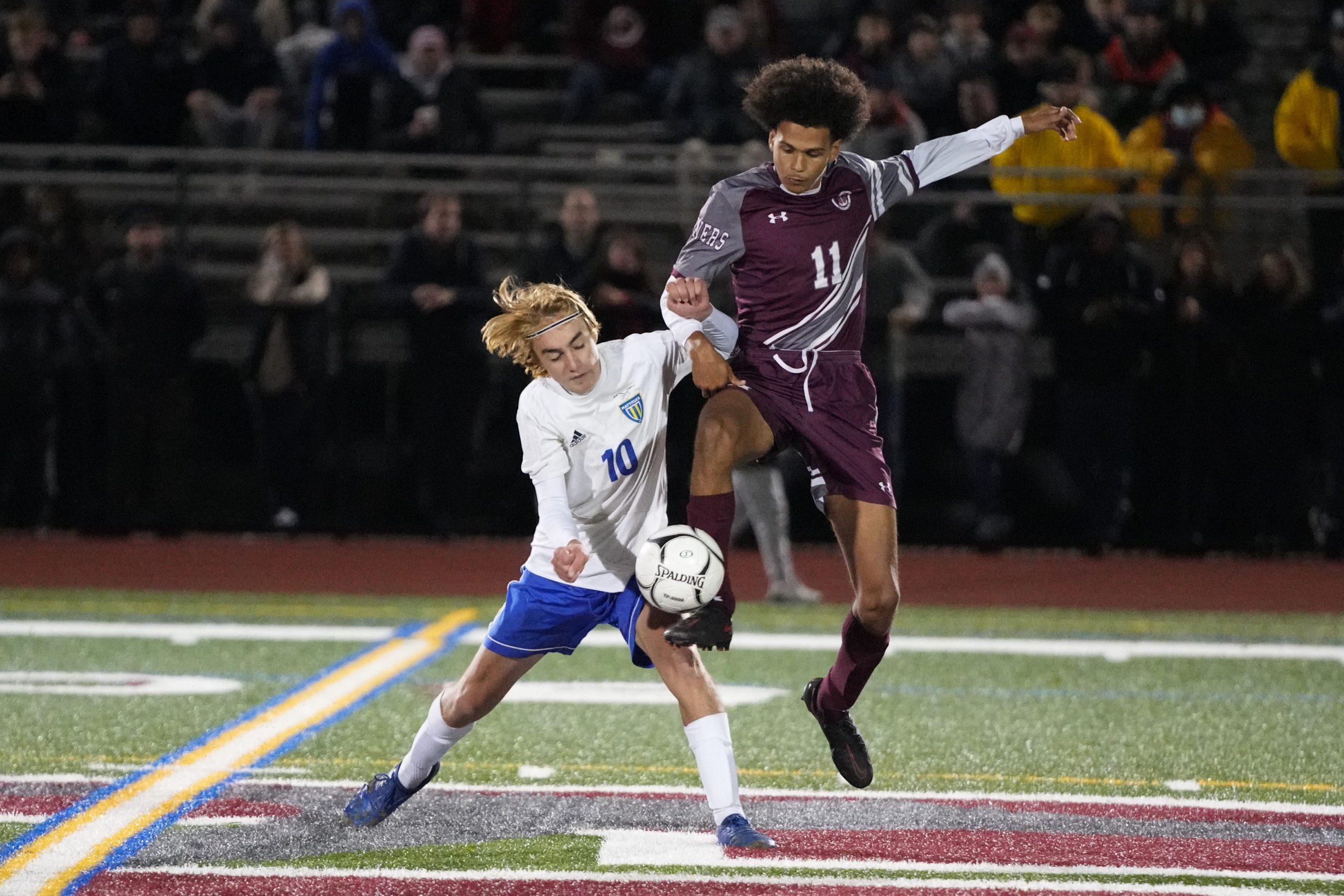 Southampton senior Armani Ray gets a foot on the ball while trying to avoid contact with Mattituck junior Erik McKenna.