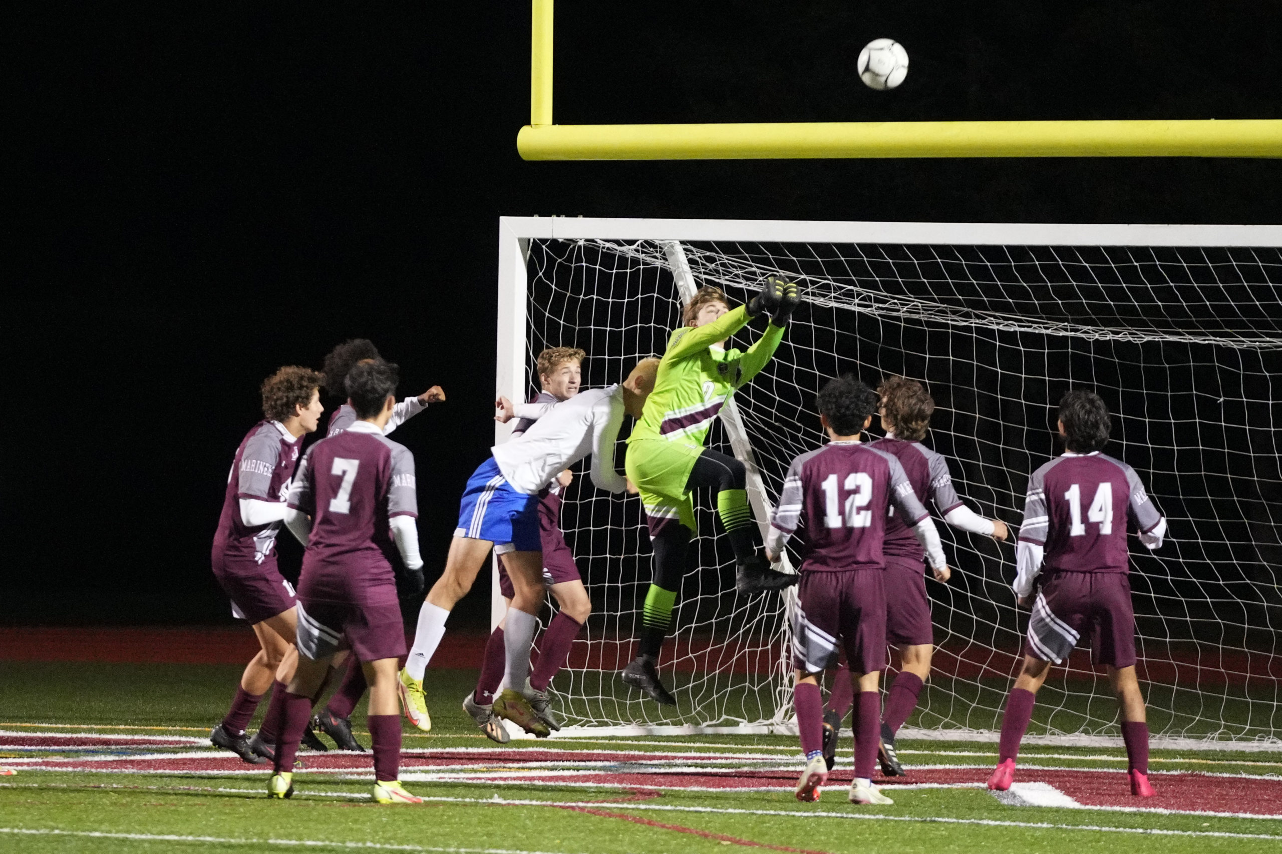 Southampton junior goalie Andy Panza comes out to punch a ball coming in.
