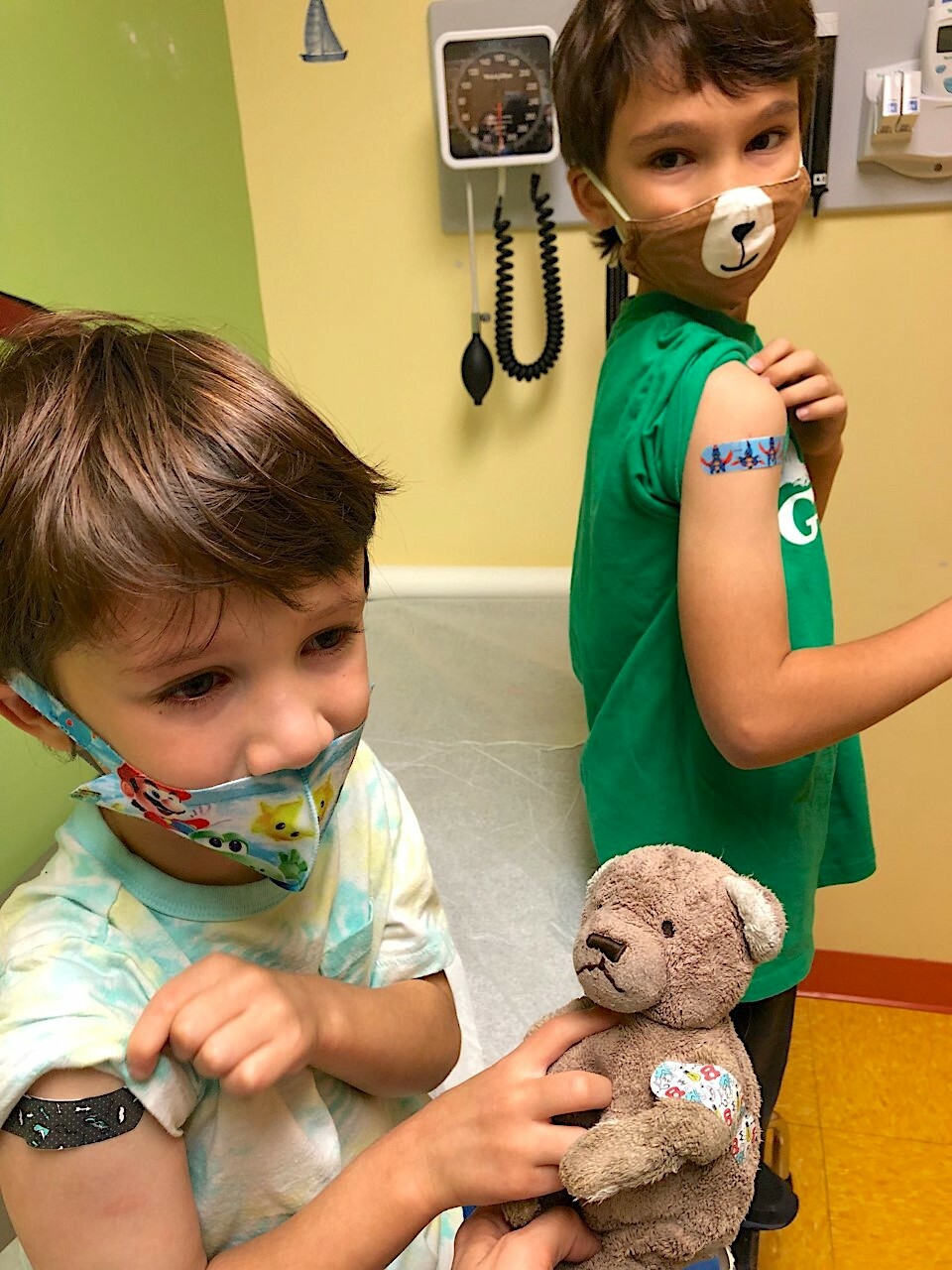 Sawyer Finn-Lerner, 3, and his 7-year-old brother, Evertt, of Port Jefferson. Evertt is all smiles after his first injection as part of Pfizer‘s COVID-19 trial in at Stony Brook Hospital. STONY BROOK MEDICINE