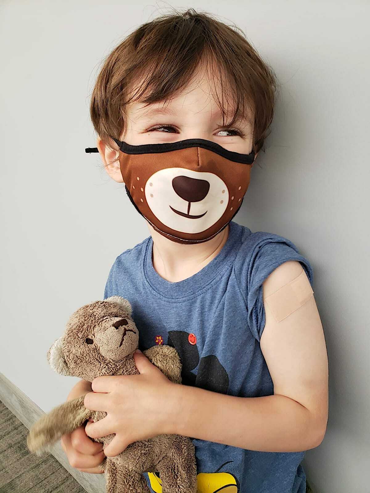 Sawyer Finn-Lerner, 3, of Port Jefferson, clutches his teddy bear after getting his first shot as part of the Moderna COVID-19 vaccine trial for kids. STONY BROOK MEDICINE