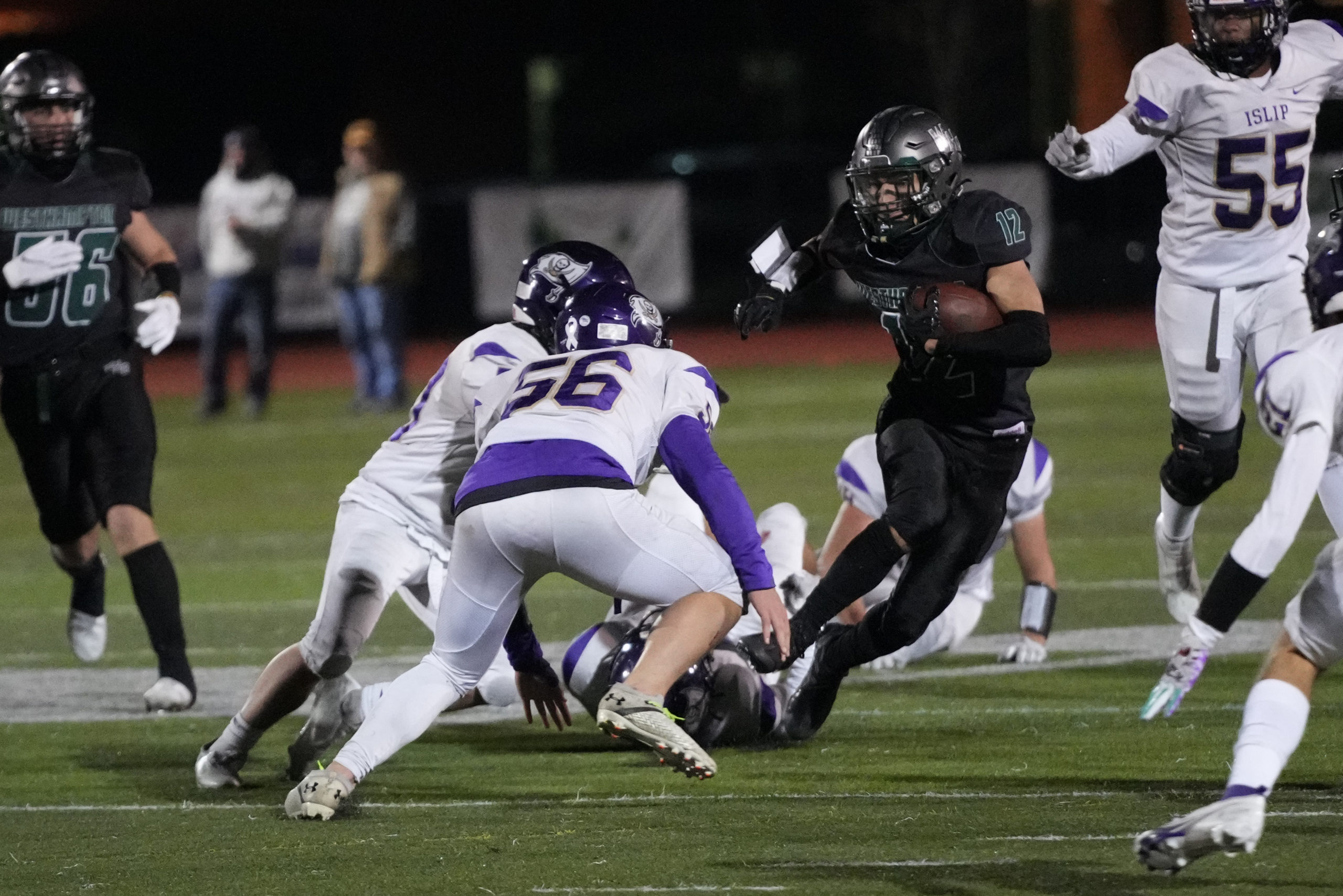 Westhampton Beach senior Deegan Laube takes on a pair of Islip defenders.