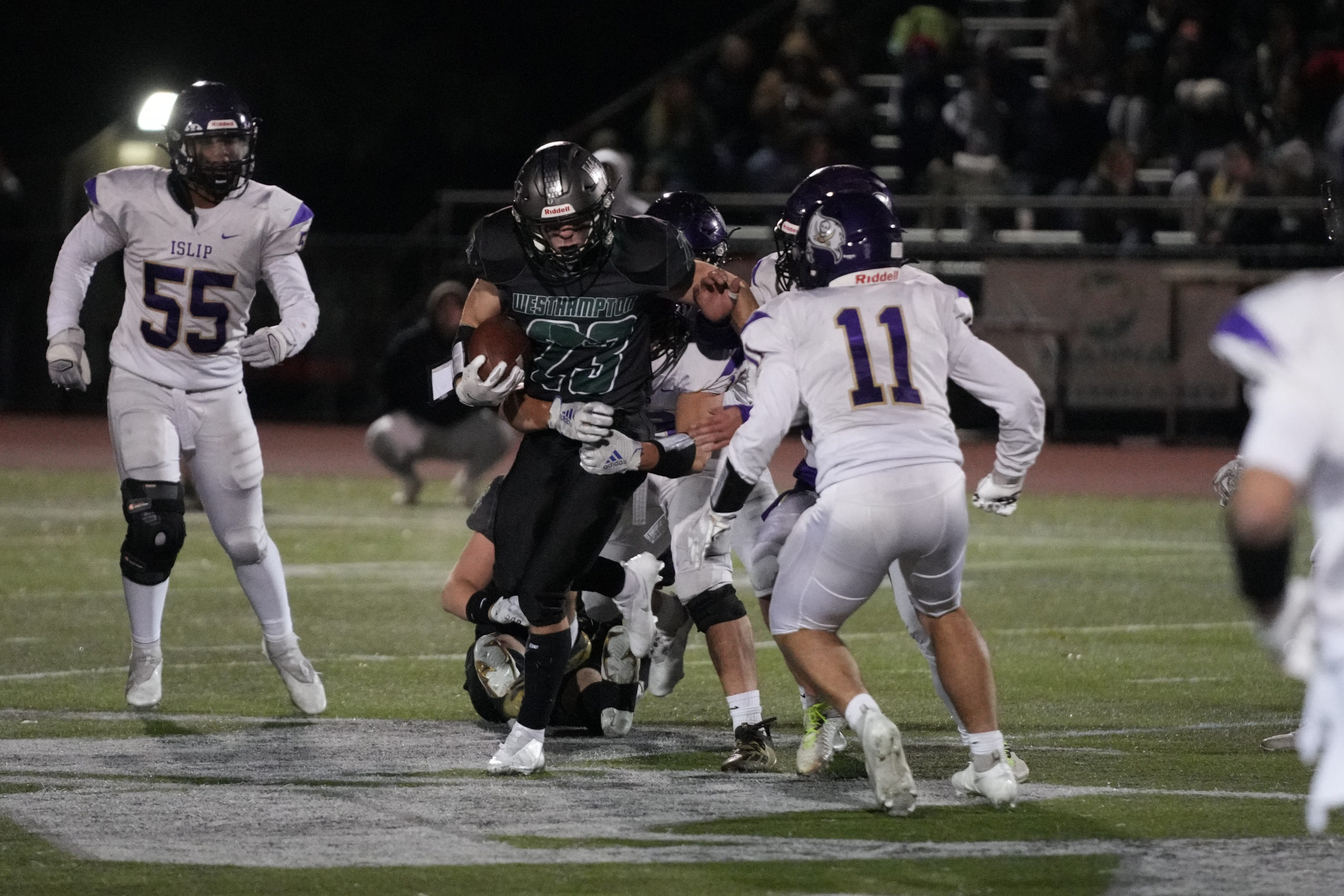 Westhampton Beach senior Robert Moreland tries to get out of the grasp of an Islip defender.
