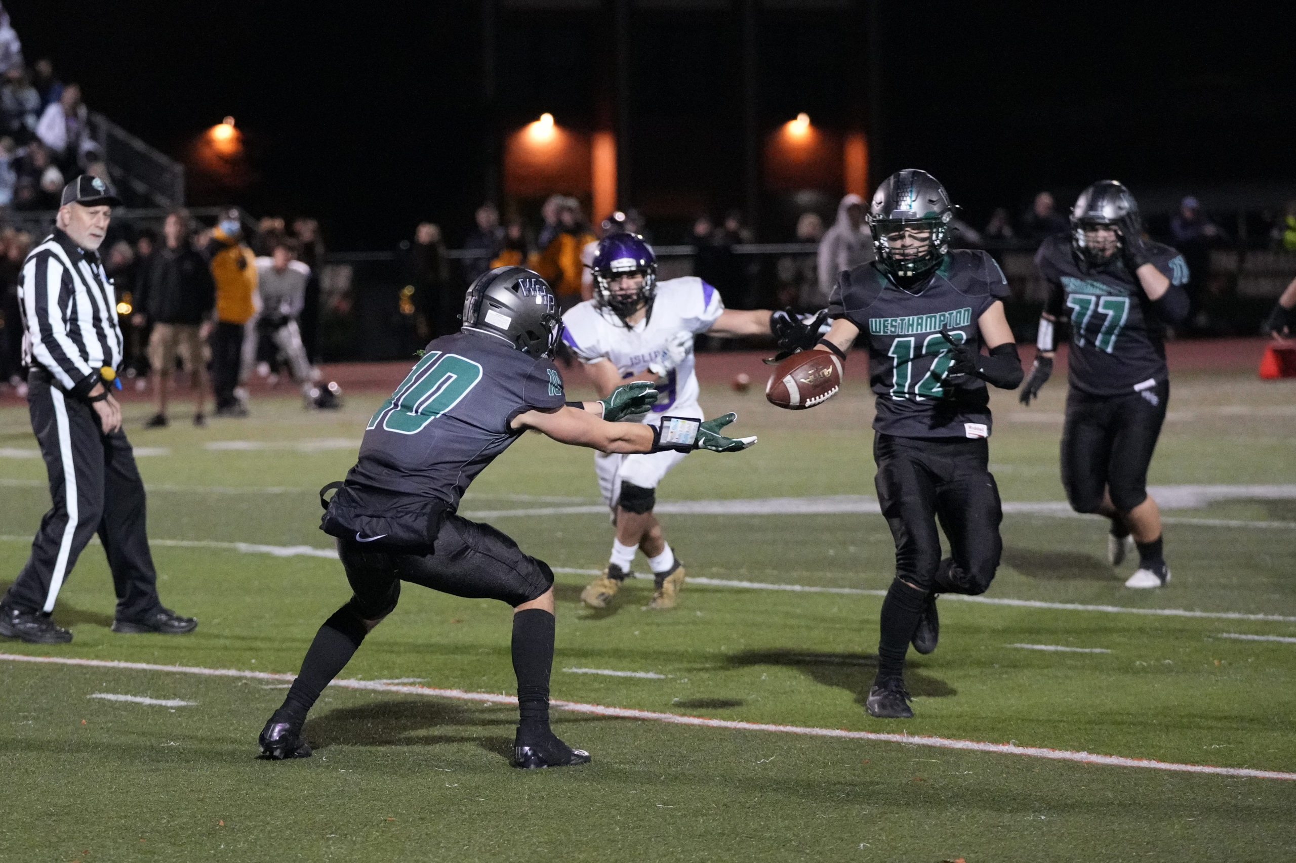 Senior Christian Killoran tosses to fellow senior Deegan Laube as the Hurricanes run a hook and ladder play toward the end of the first half on Friday night.
