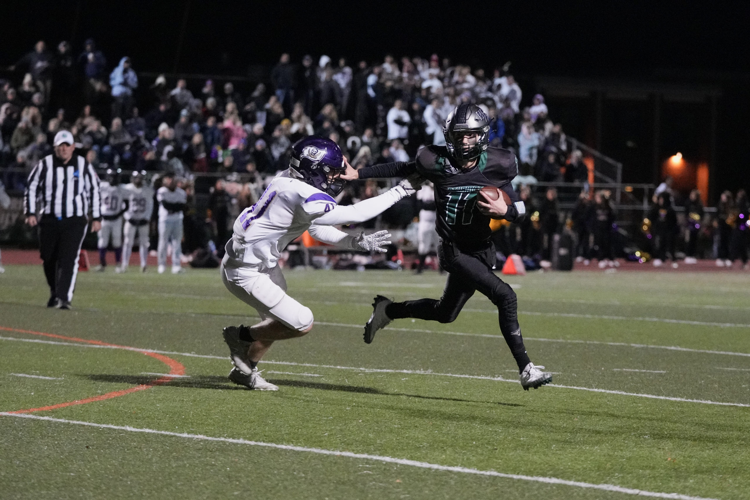 Westhampton Beach sophomore Will Gambino stiff arms an Islip player.