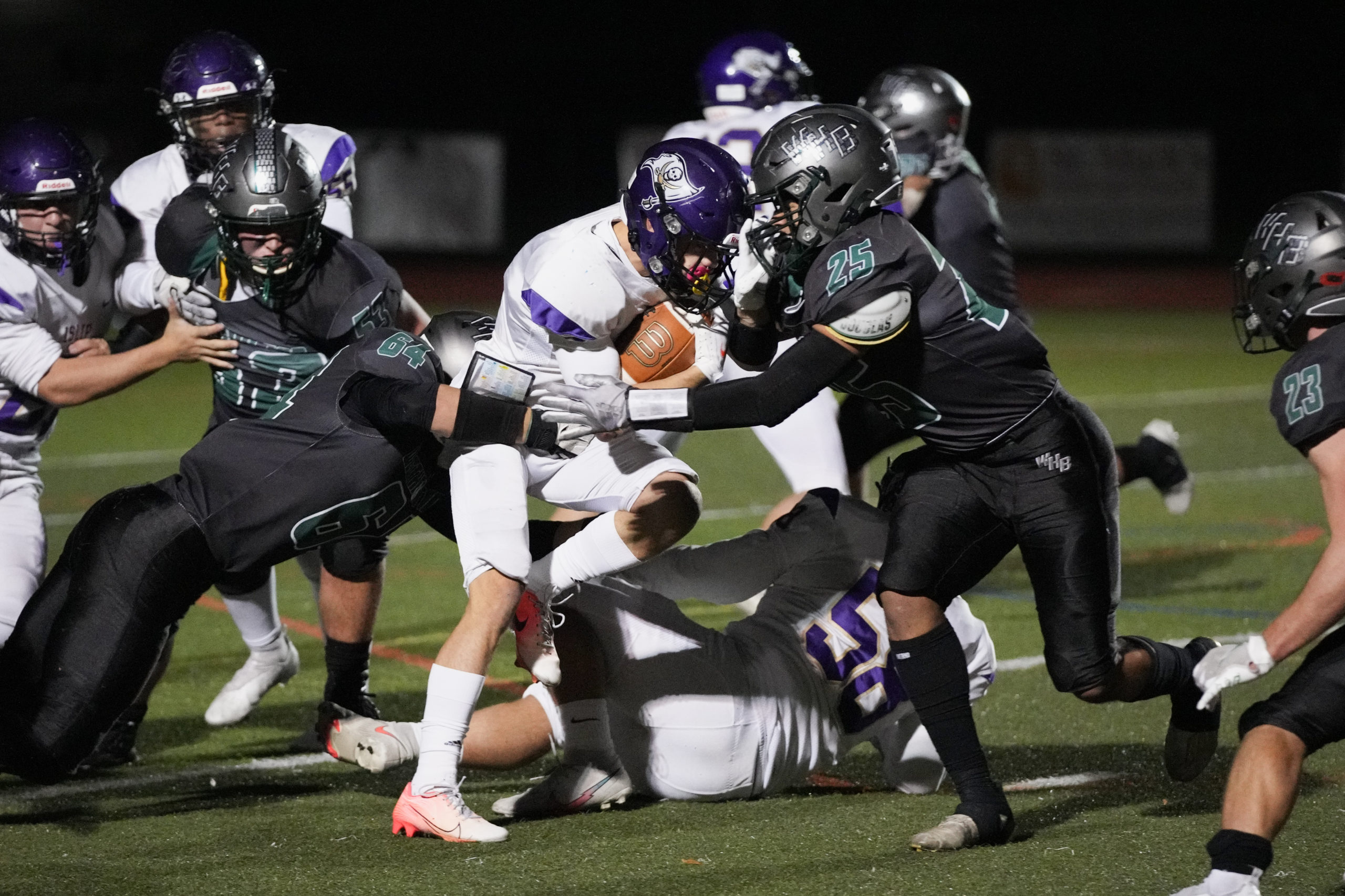 Westhampton Beach sophomore Jordyn Brown makes an initial hit on an Islip player.