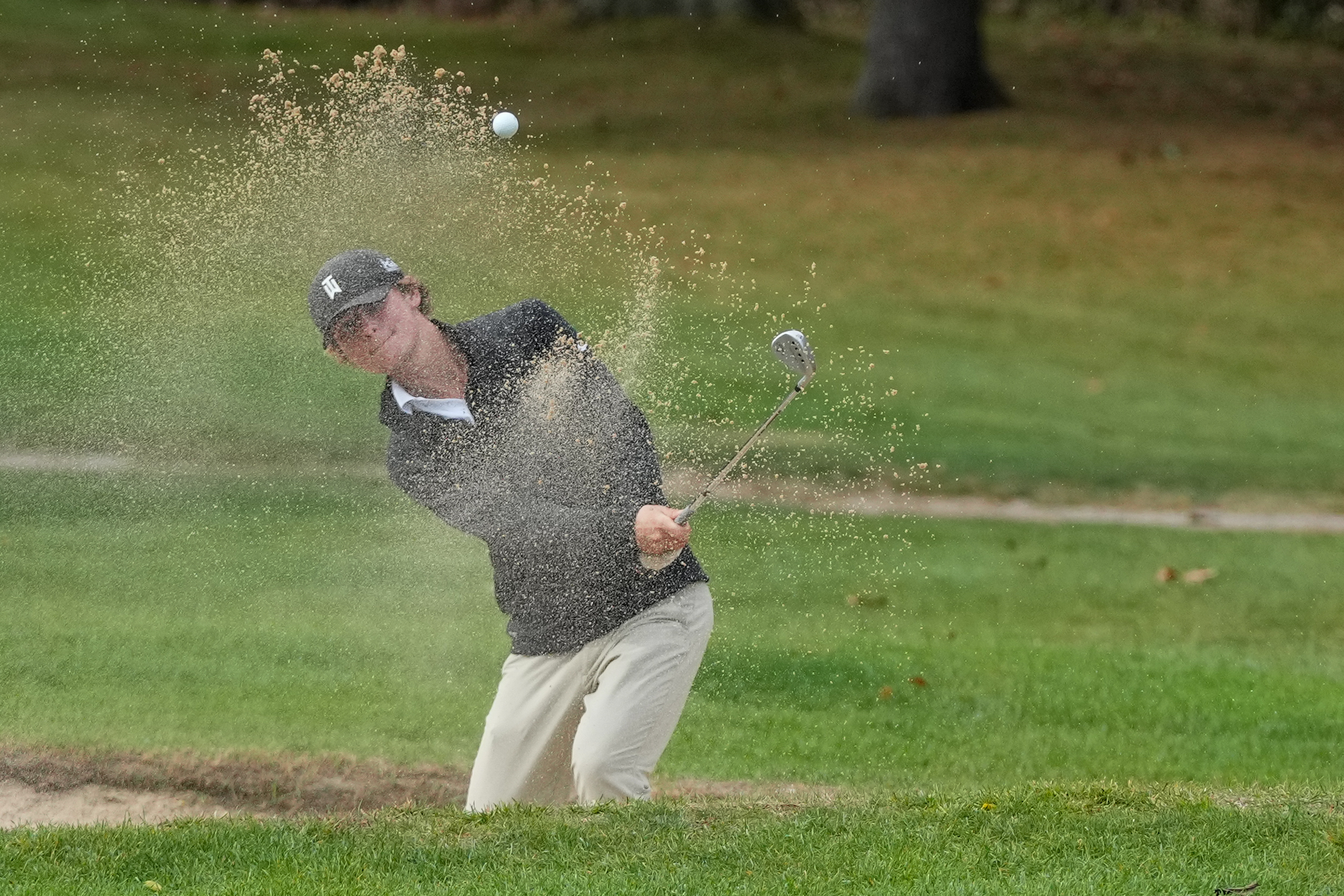 Ryan Springer of Westhampton Beach gets himself out of a trap during the first day of the Suffolk County Boys Golf Championships at Smithtown Landing on Monday.