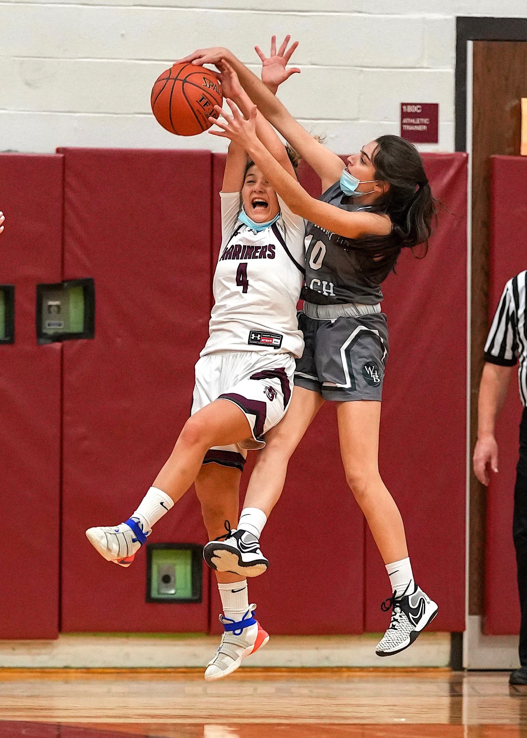 Southampton senior Gabby Arnold and Westhampton Beach classmate Allei Parascandola jump for the ball. RON ESPOSITO