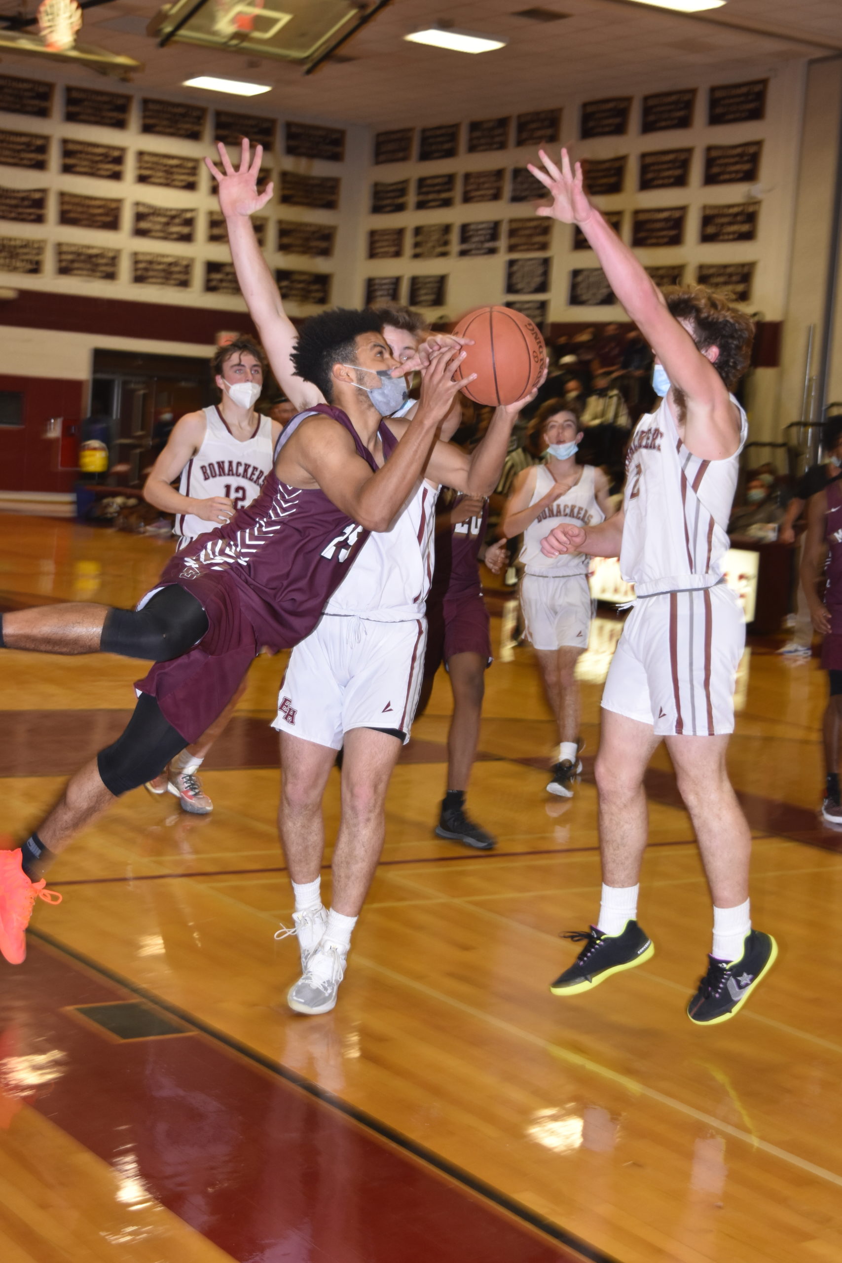 Southampton senior LeBron Napier tries to avoid a pair of East Hampton defenders but gets called for a travel.