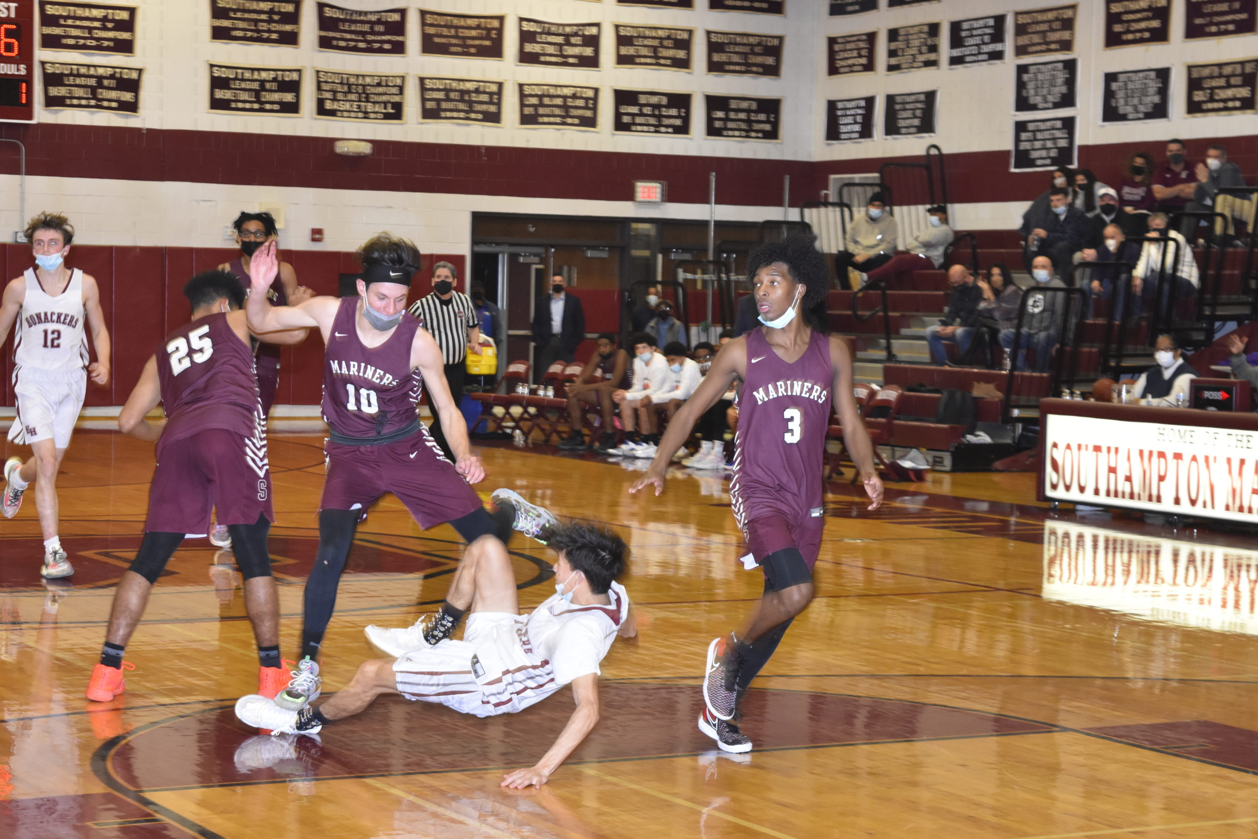 East Hampton senior Hector Montanaldo gets his ankle stepped up by Southampton senior Andrew Venesina.