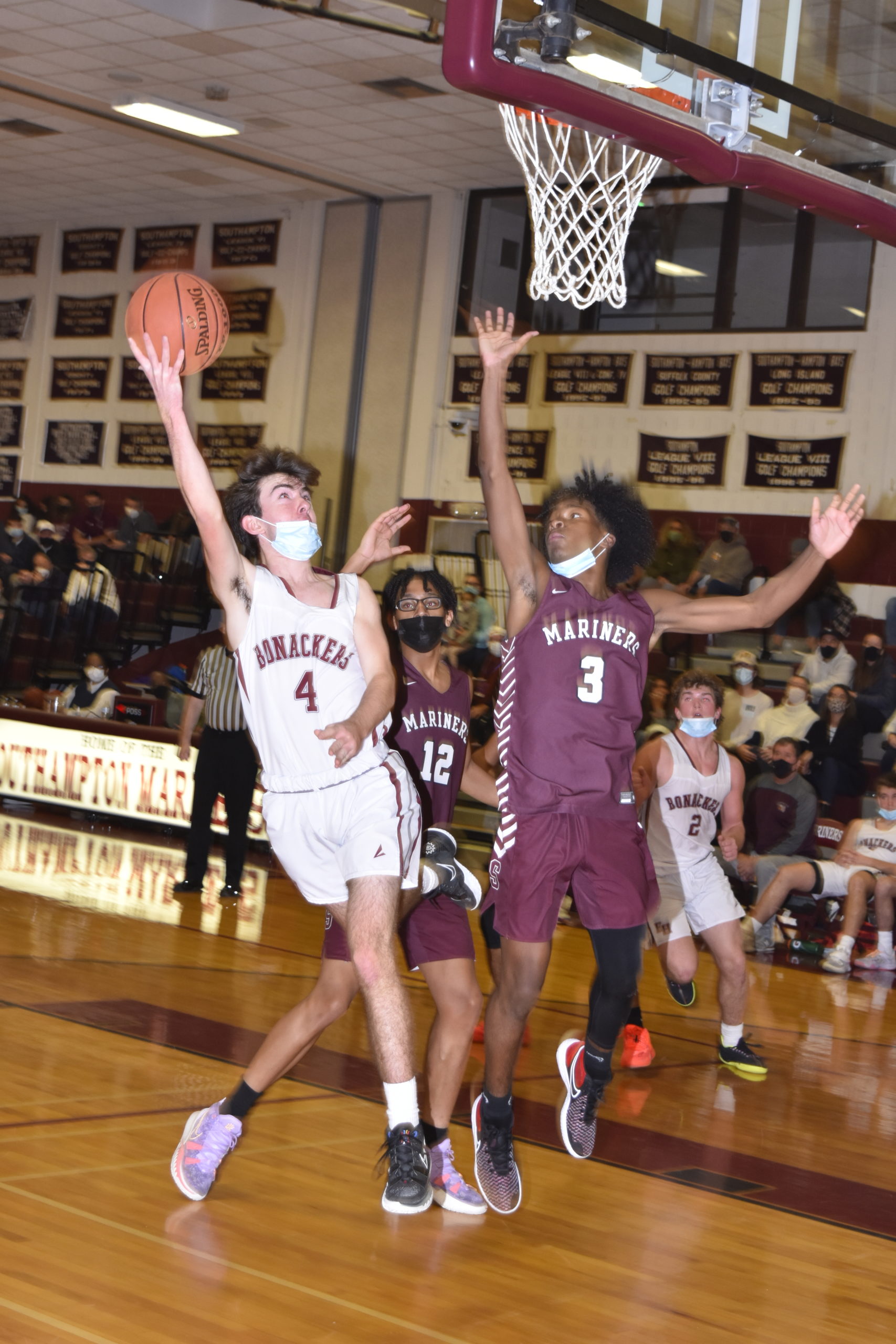 Bonac sophomore Liam Fowkes takes on both Ryan Smith and Derek Reed at the basket.